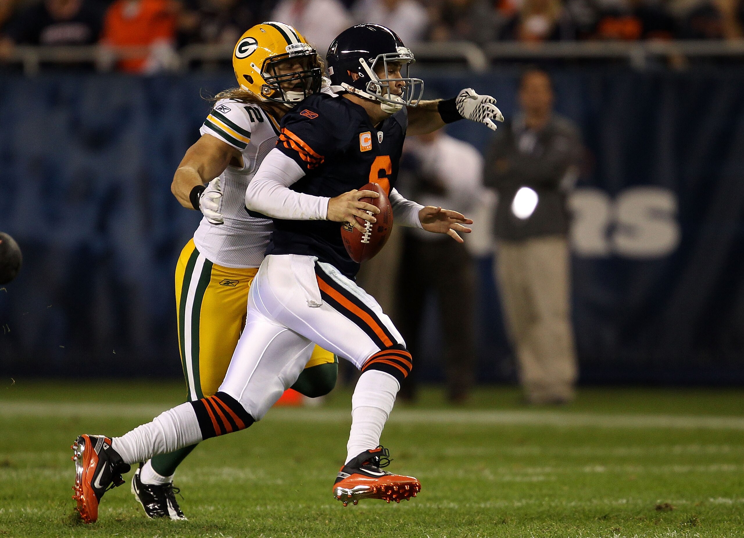 CHICAGO - SEPTEMBER 27:  Jay Cutler #6 of the Chicago Bears scrables with the ball as he is pressured by Clay Matthews #52 of the Green Bay Packers at Soldier Field on September 27, 2010 in Chicago, Illinois. Matthews was called for a facemask on the play