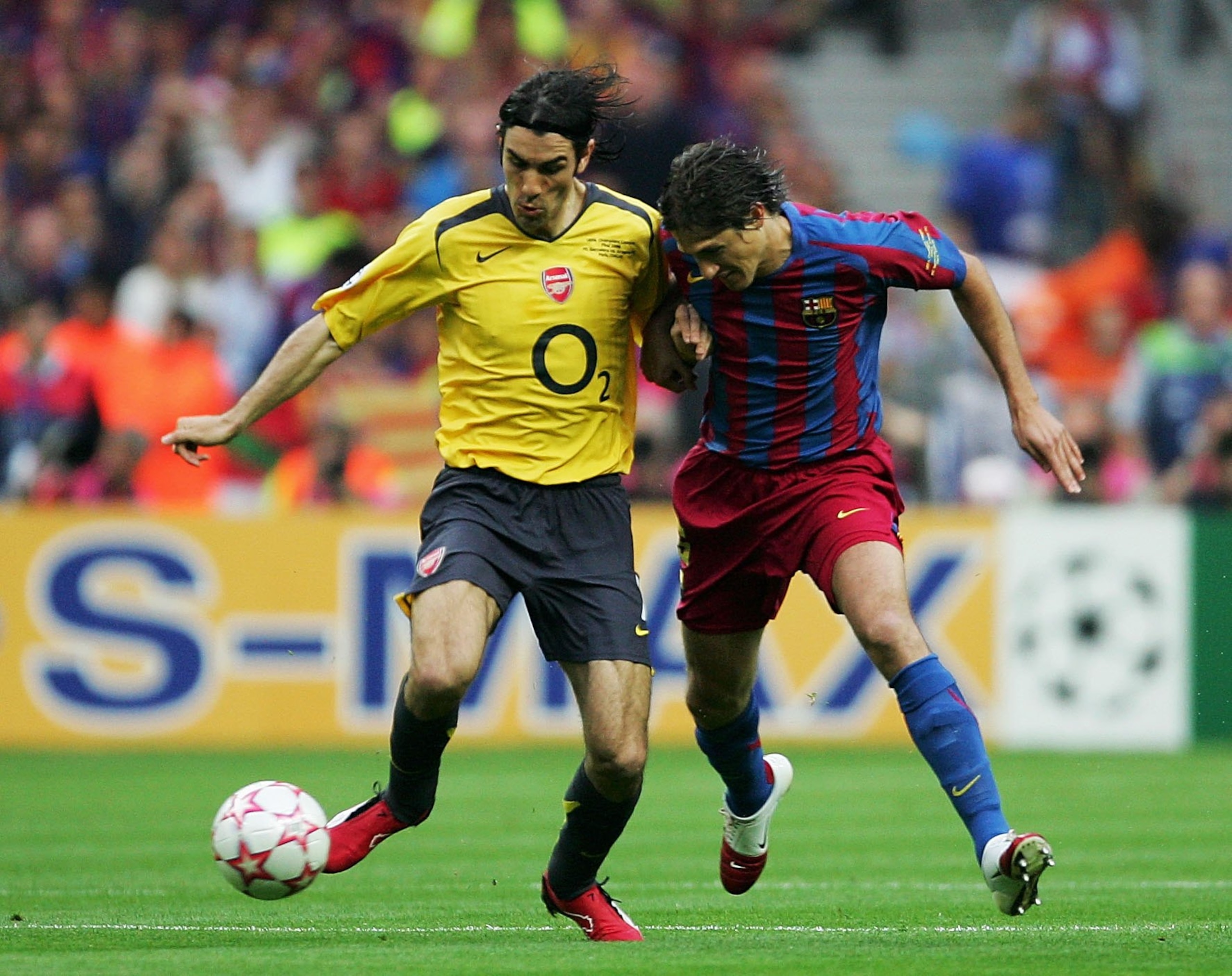PARIS - MAY 17:  (L-R) Robert Pires of Arsenal holds off the challenge of Edmilson of Barcelona during the UEFA Champions League Final between Arsenal and Barcelona at the Stade de France on May 17, 2006 in Paris, France.  (Photo by Alex Livesey/Getty Ima