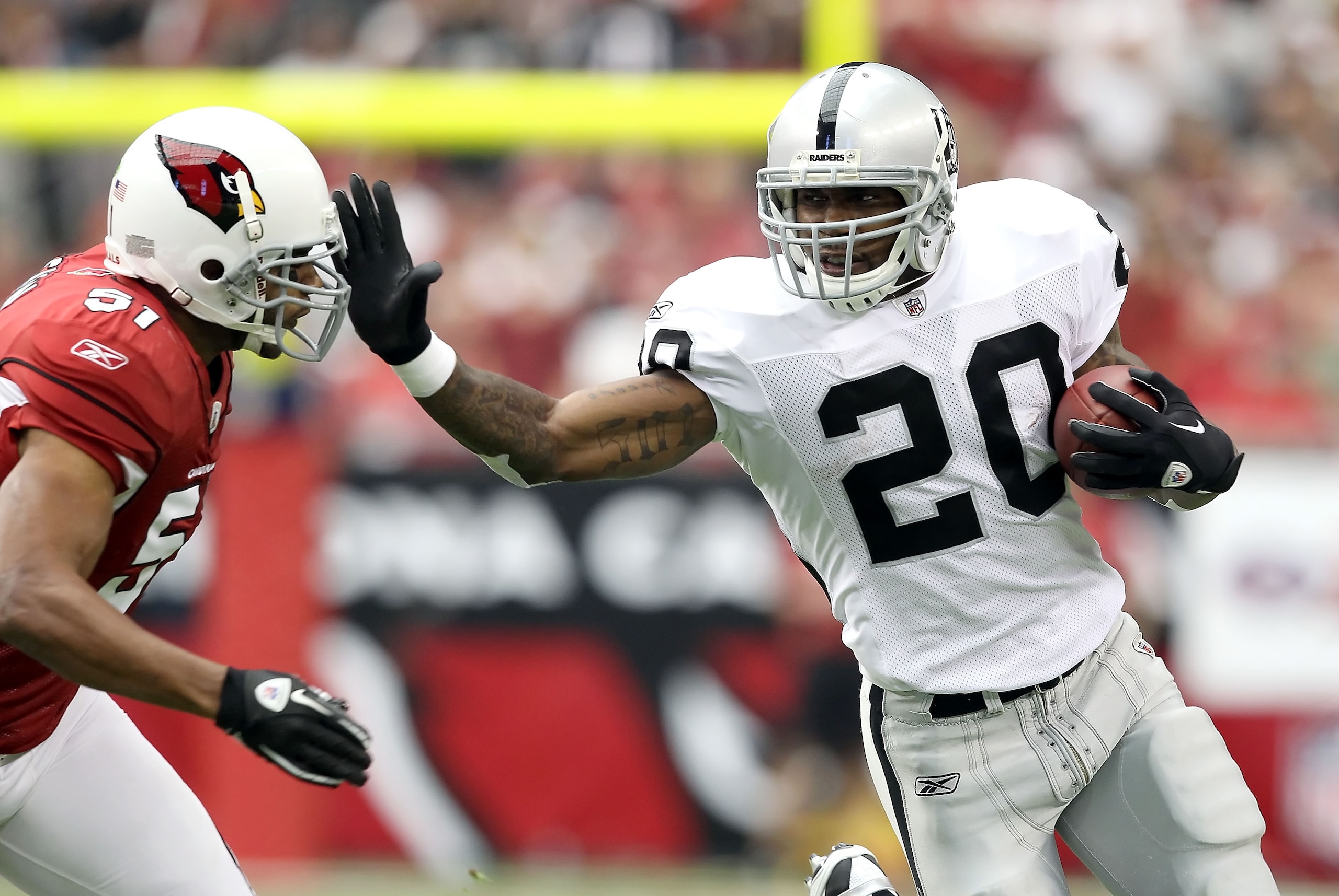 GLENDALE, AZ - SEPTEMBER 26: Runningback Darren McFadden #20 of the Oakland Raiders rushes the football past Paris Lenon #51 of the Arizona Cardinals during the first quarter of the NFL game at the University of Phoenix Stadium on September 26, 2010 in G GLENDALE, AZ - SEPTEMBER 26: Runningback Darren McFadden #20 of the Oakland Raiders rushes the football past Paris Lenon #51 of the Arizona Cardinals during the first quarter of the NFL game at the University of Phoenix Stadium on September 26, 2010 in G