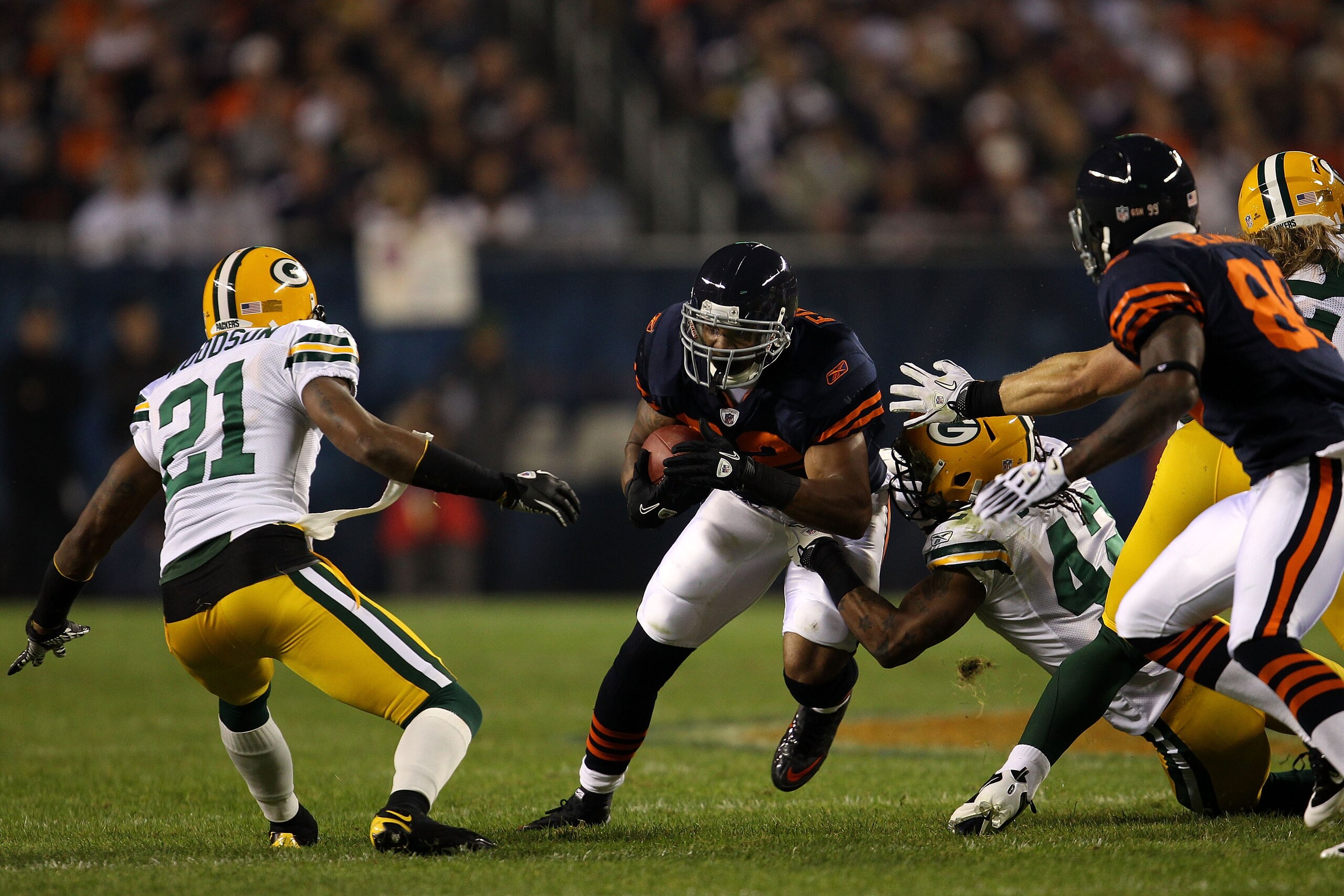 CHICAGO - SEPTEMBER 27:  Matt Forte #22 of the Chicago Bears runs the ball in the first quarter against Charles Woodson #21 and Morgan Burnett #42 of the Green Bay Packers at Soldier Field on September 27, 2010 in Chicago, Illinois.  (Photo by Jonathan Da