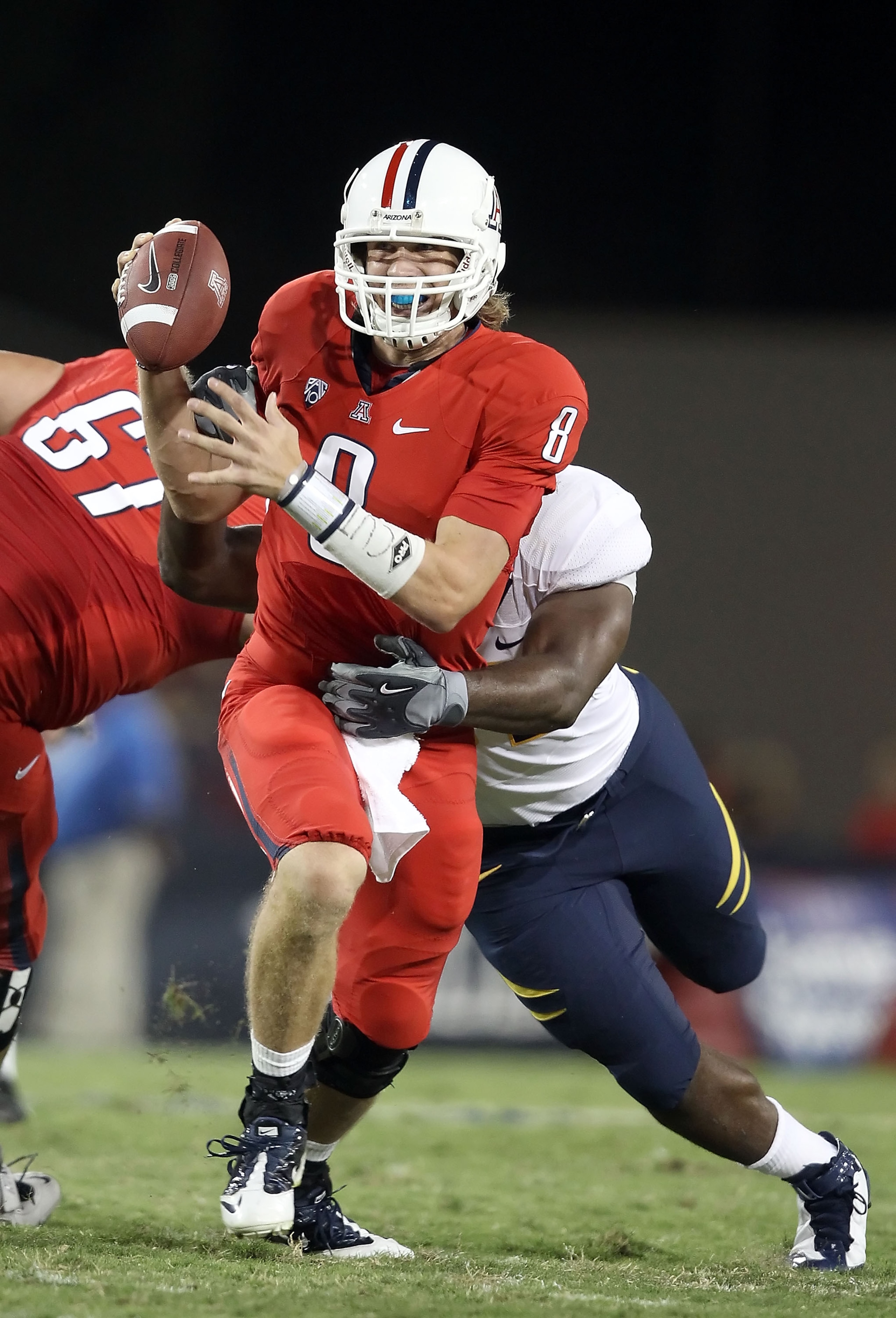TUCSON, AZ - SEPTEMBER 25:  Quarterback Nick Foles #8 of the Arizona Wildcats scrambles with the ball during the college football game against the California Golden Bears at Arizona Stadium on September 25, 2010 in Tucson, Arizona.   The Wildcats defeated