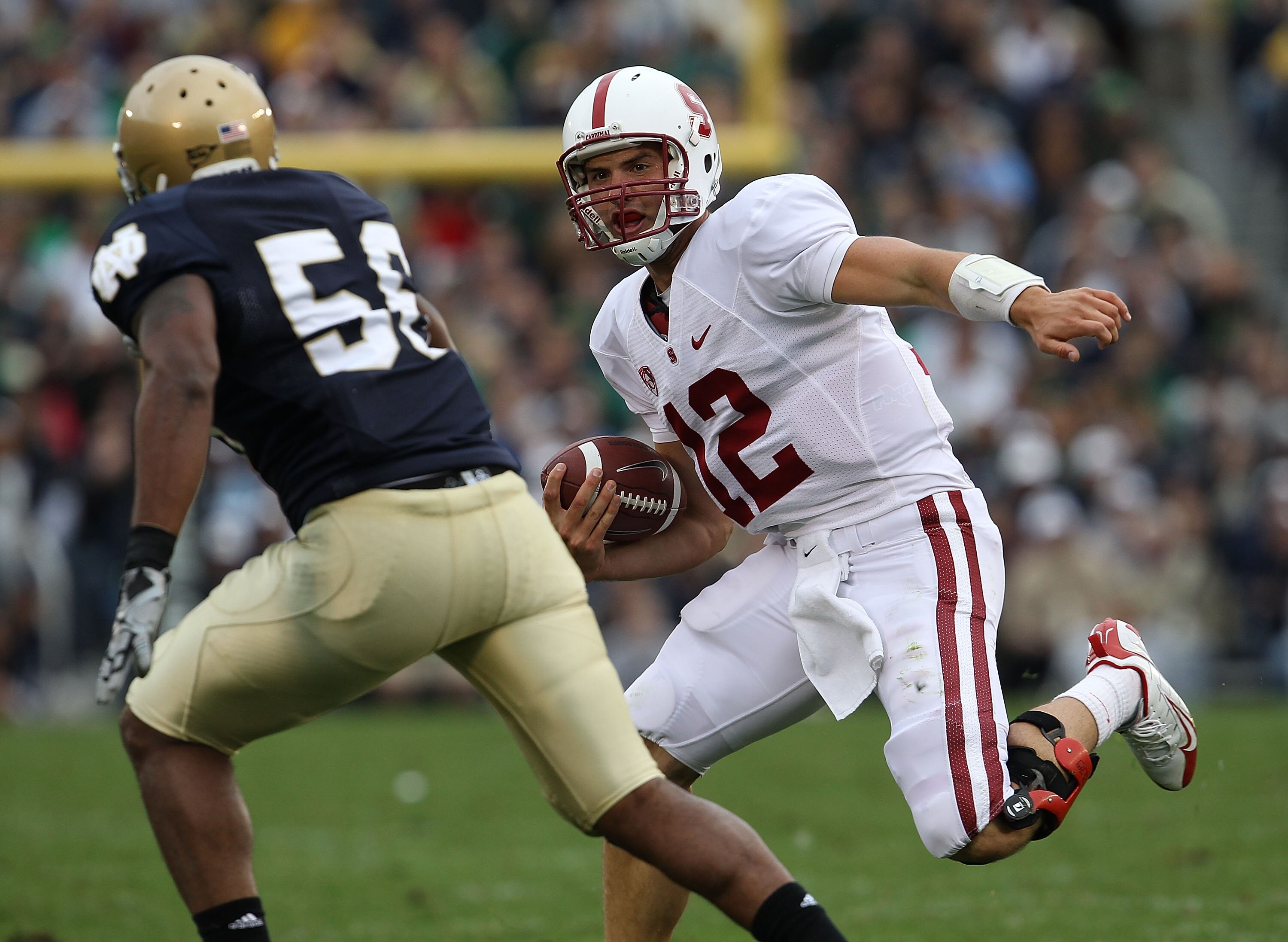 SOUTH BEND, IN - SEPTEMBER 25: Andrew Luck #12 of the Stanford Cardinal runs for yardage as Kerry Neal #56 of the Notre Dame Fighting Irish closes in at Notre Dame Stadium on September 25, 2010 in South Bend, Indiana. (Photo by Jonathan Daniel/Getty Image