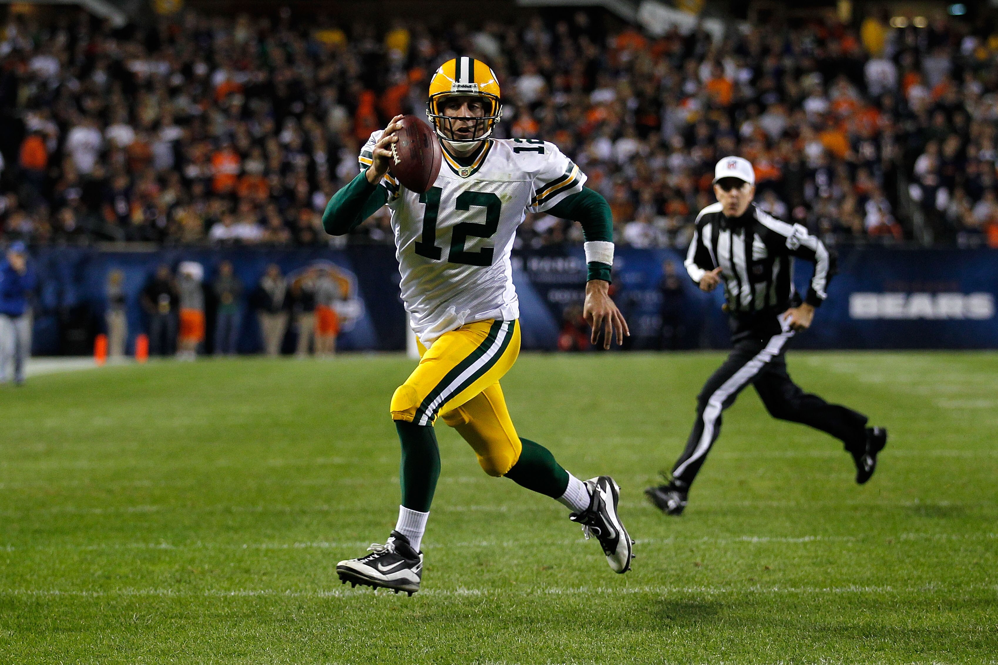 CHICAGO - SEPTEMBER 27:  Aaron Rodgers #12 of the Green Bay Packers runs for a 3-yard rushing touchdown in the fourth quarter against the Chicago Bears at Soldier Field on September 27, 2010 in Chicago, Illinois.  (Photo by Jonathan Daniel/Getty Images)