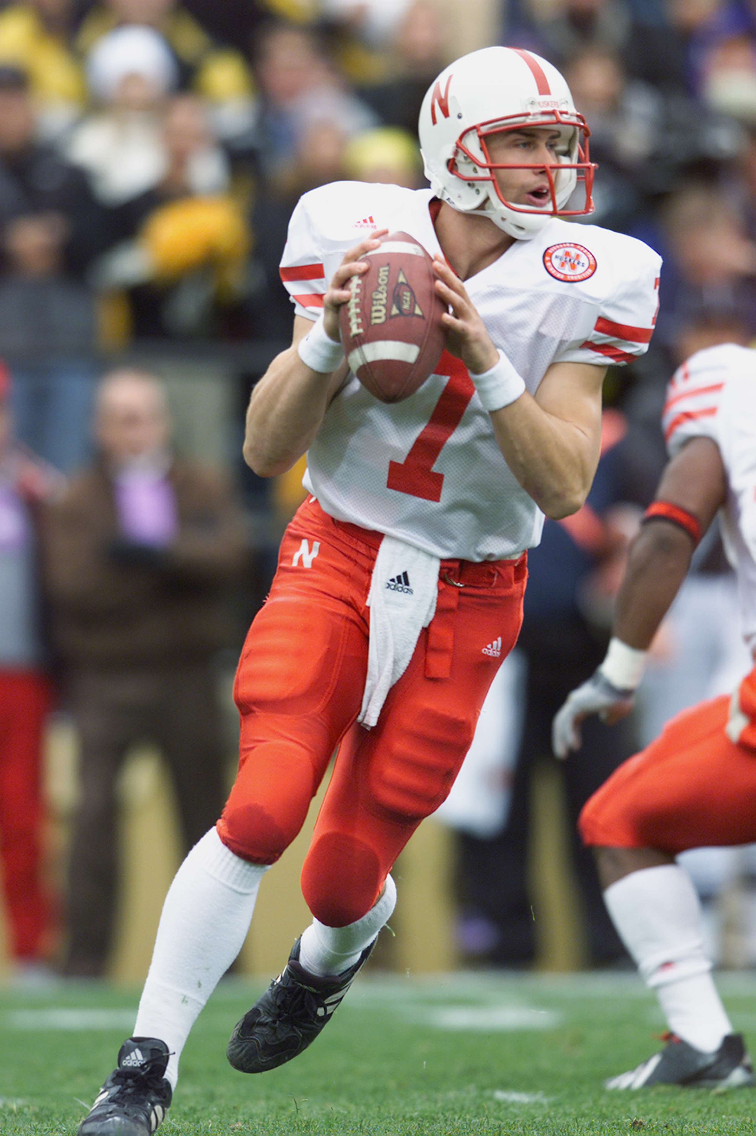 BOULDER, CO - NOVEMBER 23:  Quarterback Eric Crouch #7 of the Nebraska Cornhuskers rolls to his right during the Big 12 Conference football game against the Colorado Buffaloes on November 23, 2001 at Folsom Field in Boulder, Colorado.  The Buffaloes crush