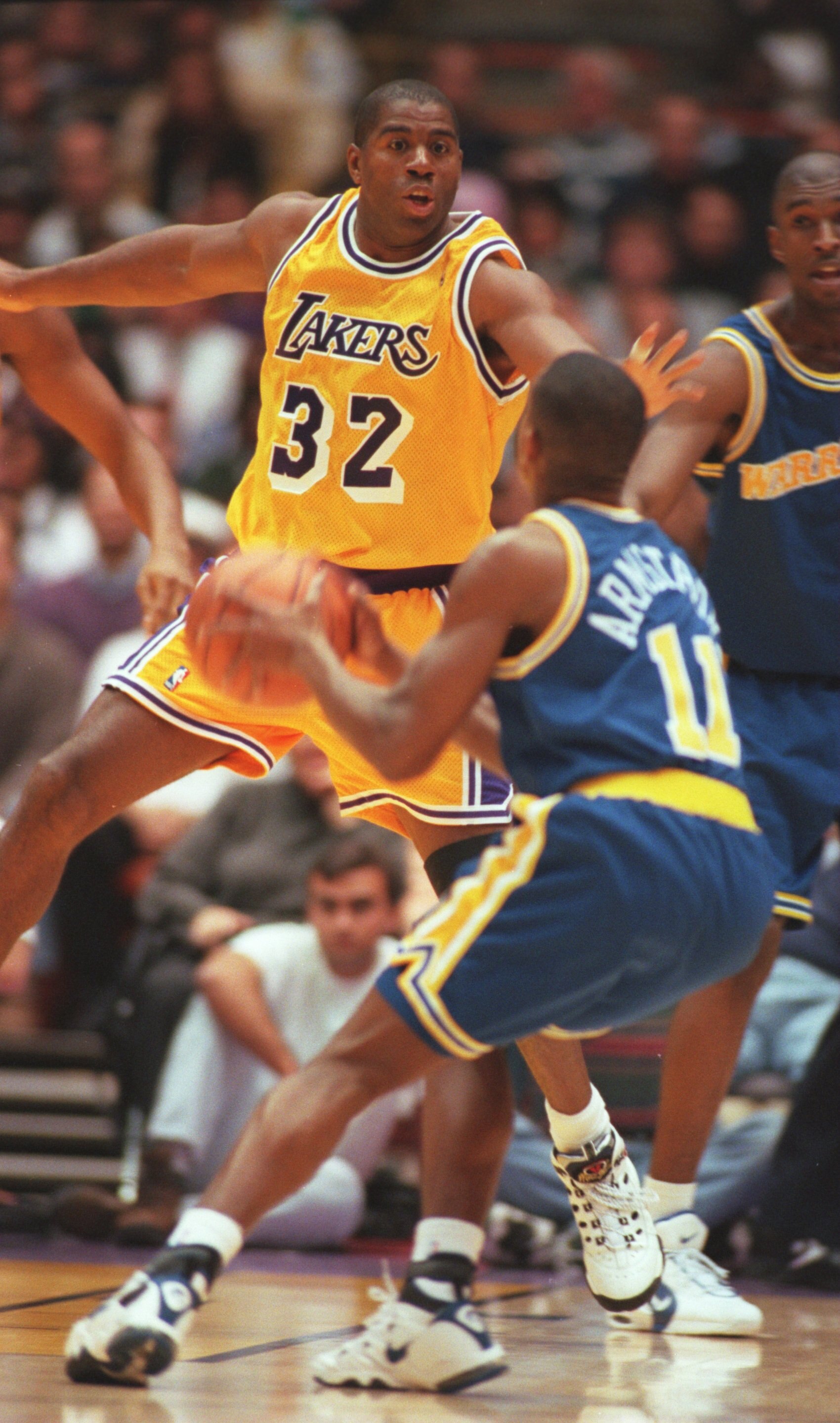 30 Jan 1996: Earvin Magic Johnson #32 defends against B.J. Armstrong #11 of the Golden State Warriors in his return to the NBA during the game at the Great Western Forum in Inglewood, California.