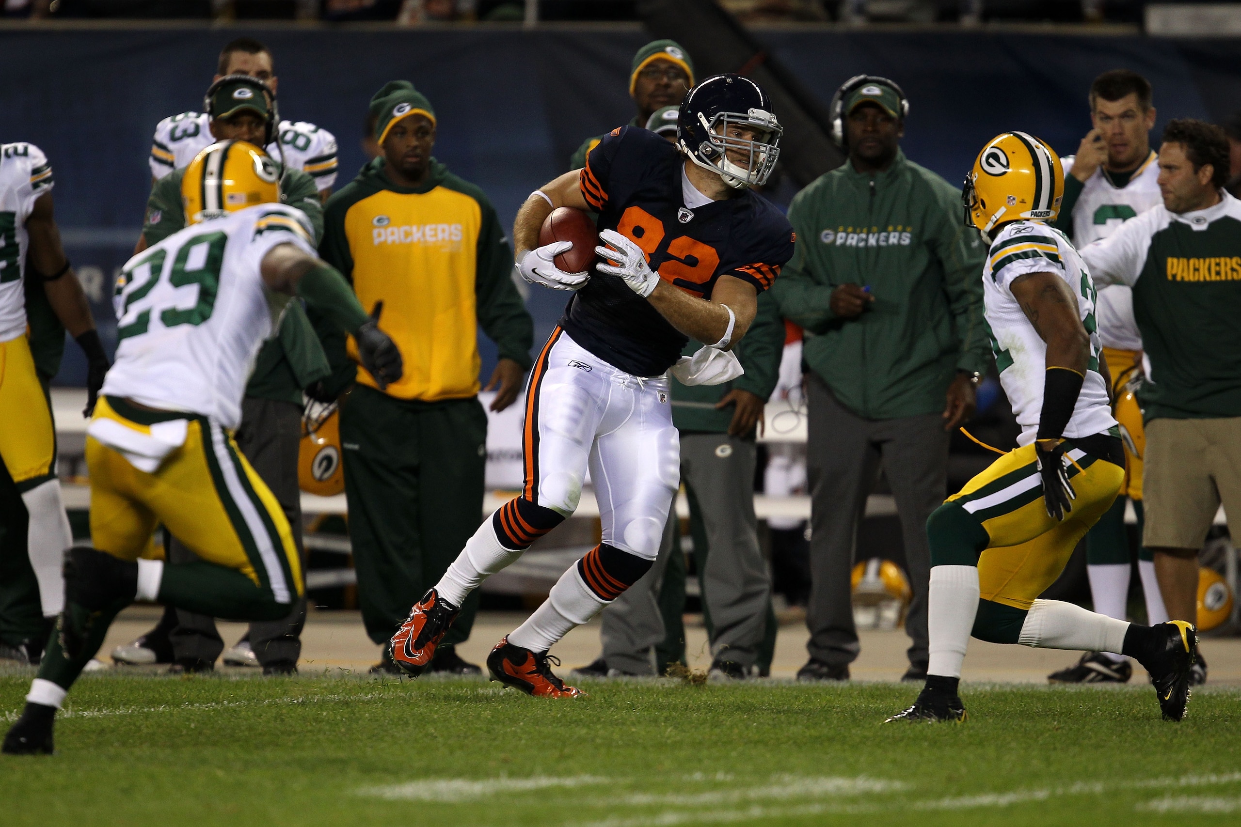 CHICAGO - SEPTEMBER 27:  Greg Olsen #82 of the Chicago Bears runs for yards after the catch against Derrick Martin #29 and Charles Woodson #21 of the Green Bay Packers at Soldier Field on September 27, 2010 in Chicago, Illinois.  (Photo by Jonathan Daniel