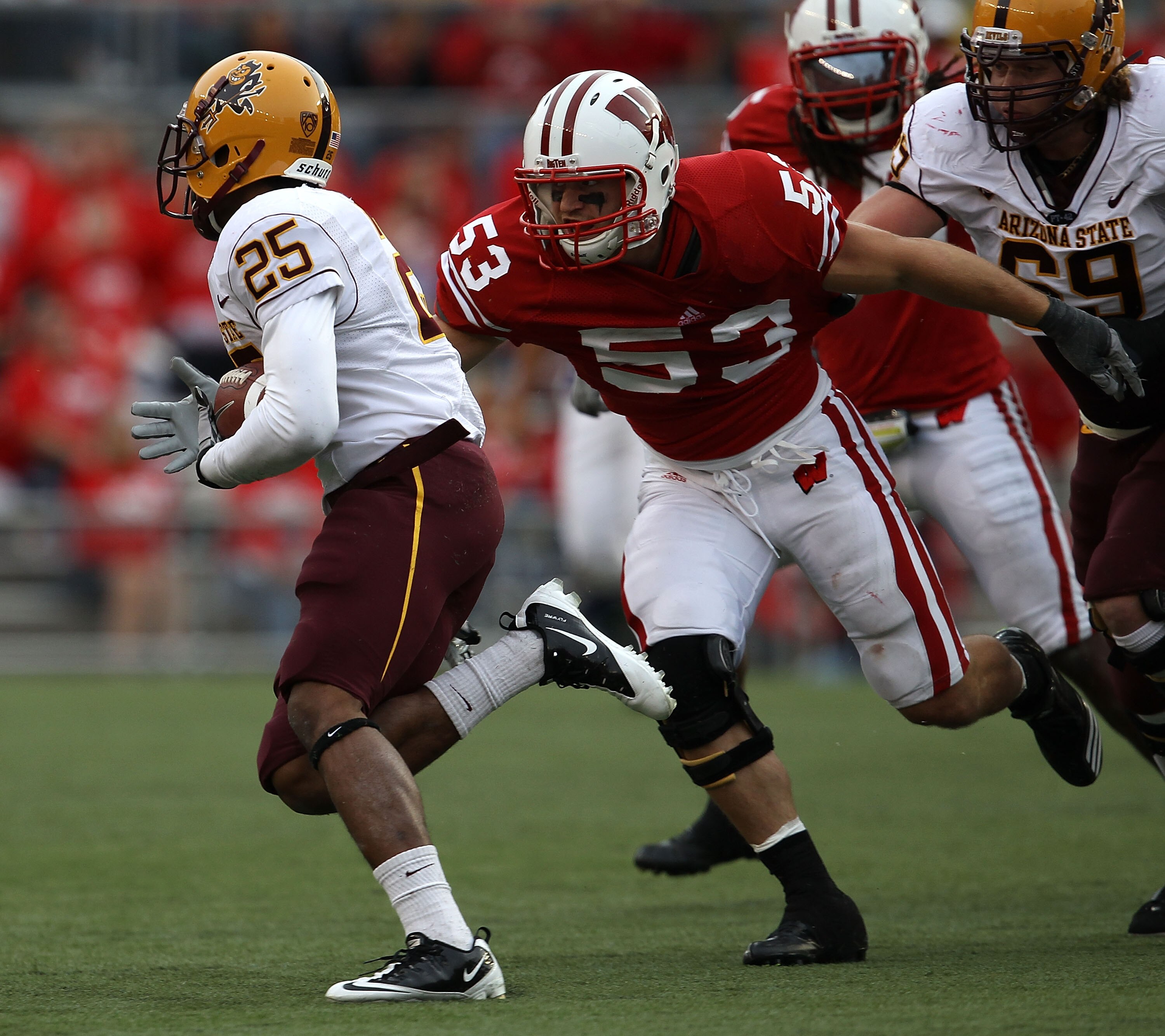 MADISON, WI - SEPTEMBER 18: Mike Taylor #53 of the Wisconsin Badgers closes in on Deantre Lewis #25 of the Arizona State Sun Devils at Camp Randall Stadium on September 18, 2010 in Madison, Wisconsin. Wisconsin defeated Arizona State 20-19. (Photo by Jona