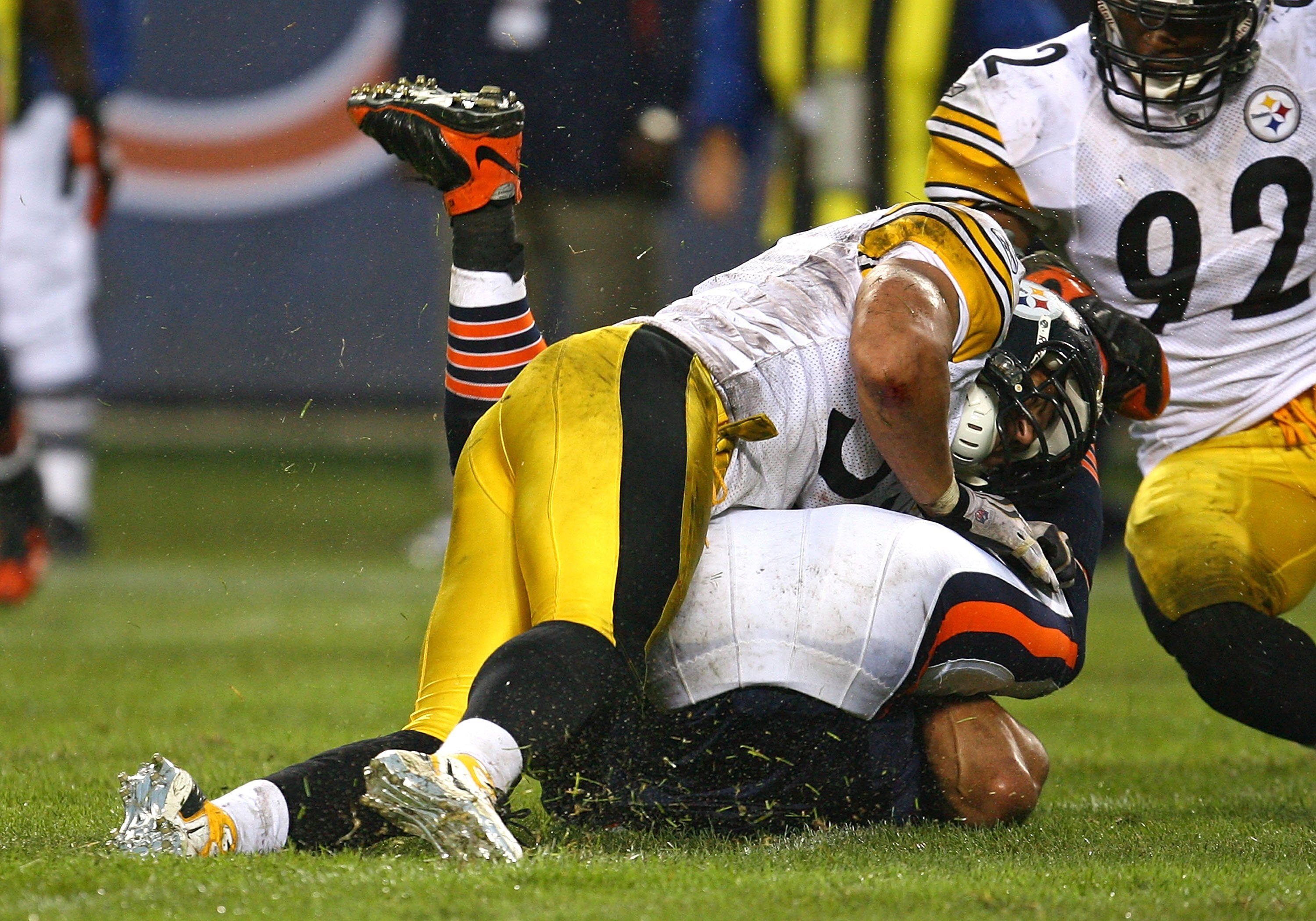 CHICAGO - SEPTEMBER 20: Greg Olsen #82 of the Chicago Bears is upended by James Farrior #51 of the Pittsburgh Steelers as teammate James Harrison #92 moves in on September 20, 2009 at Soldier Field in Chicago, Illinois. The Bears defeated the Steelers 17-