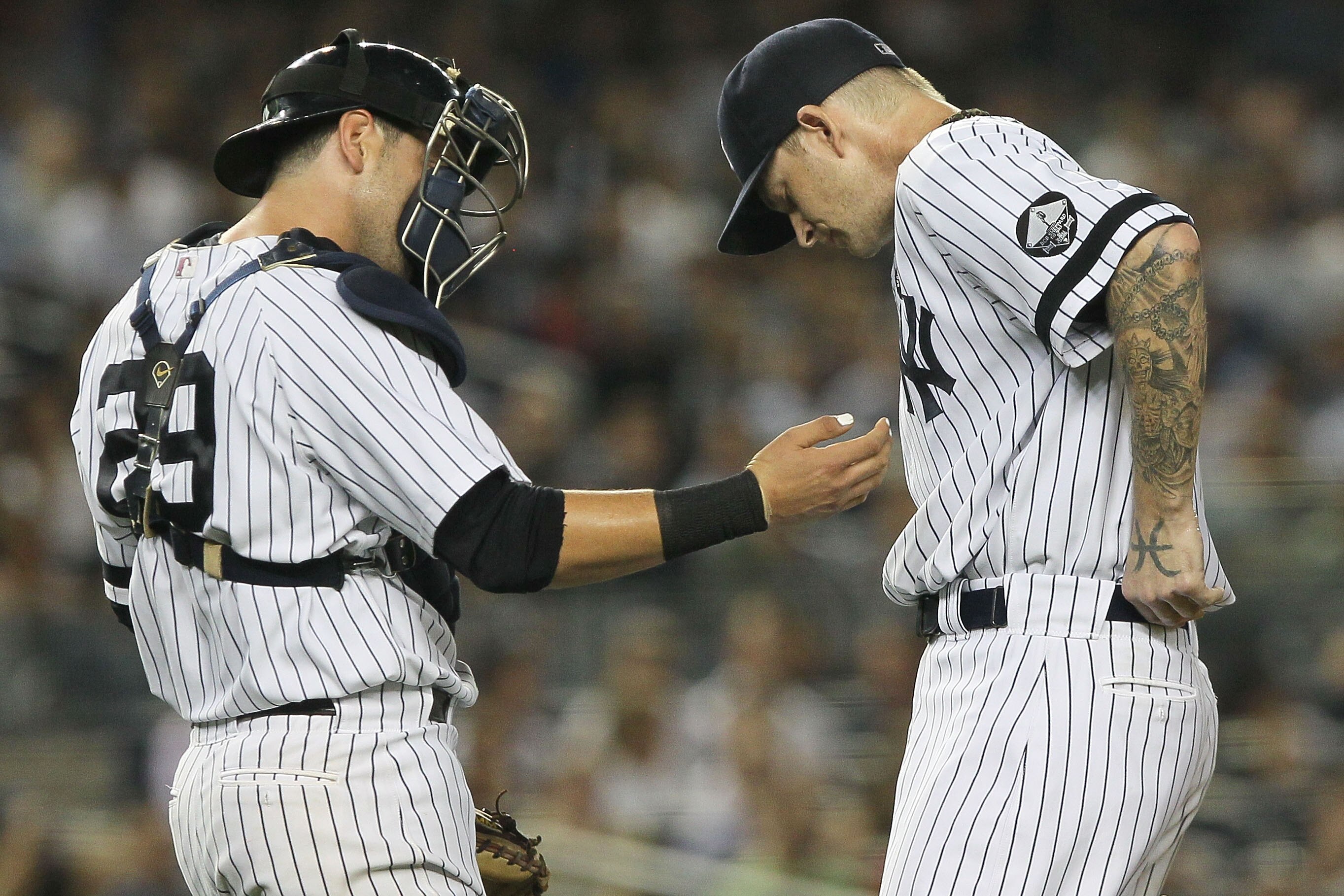 NEW YORK - SEPTEMBER 22: Francisco Cervelli #29 of the New York Yankees talks with team mate A.J Burnett #34 in the third inning against the Tampa Bay Rays during their game on September 22, 2010 at Yankee Stadium in the Bronx borough of New York City.  (