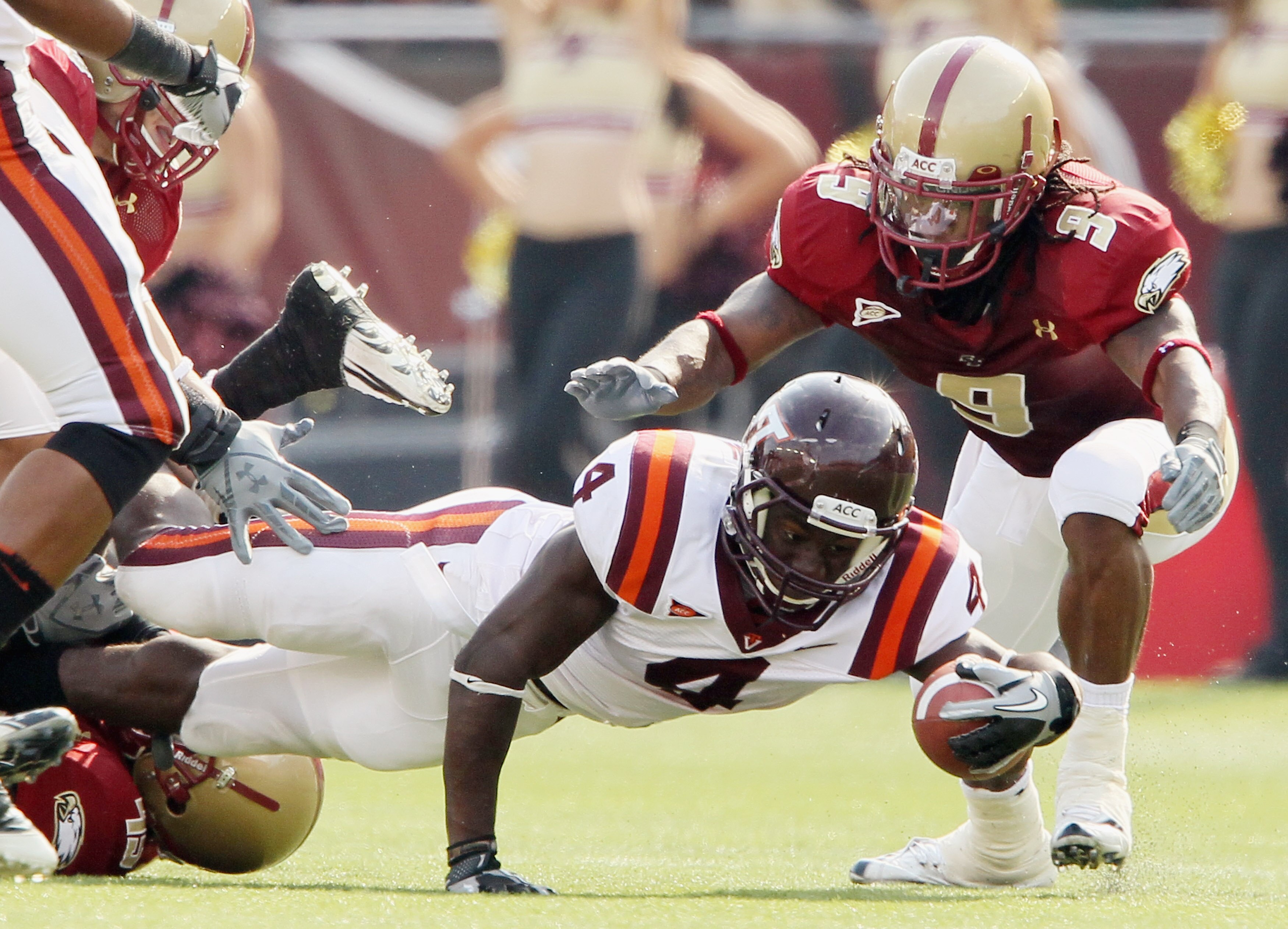 CHESTNUT HILL, MA - SEPTEMBER 25:  David Wilson #4  of the Virginia Tech Hokies is tackled as DeLeon Gause #9 of the Boston College Eagles defends on September 25, 2010 at Alumni Stadium in Chestnut Hill, Massachusetts. Virginia Tech defeated Boston Colle