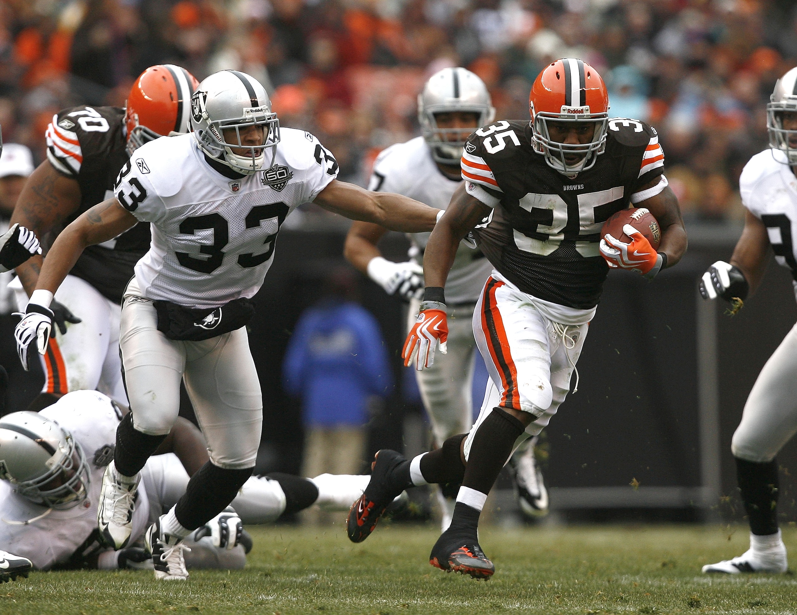 CLEVELAND - DECEMBER 27:  Jerome Harrison #35 of the Cleveland Browns runs by Tyvon Branch #33 of the Oakland Raiders at Cleveland Browns Stadium on December 27, 2009 in Cleveland, Ohio.  (Photo by Matt Sullivan/Getty Images)