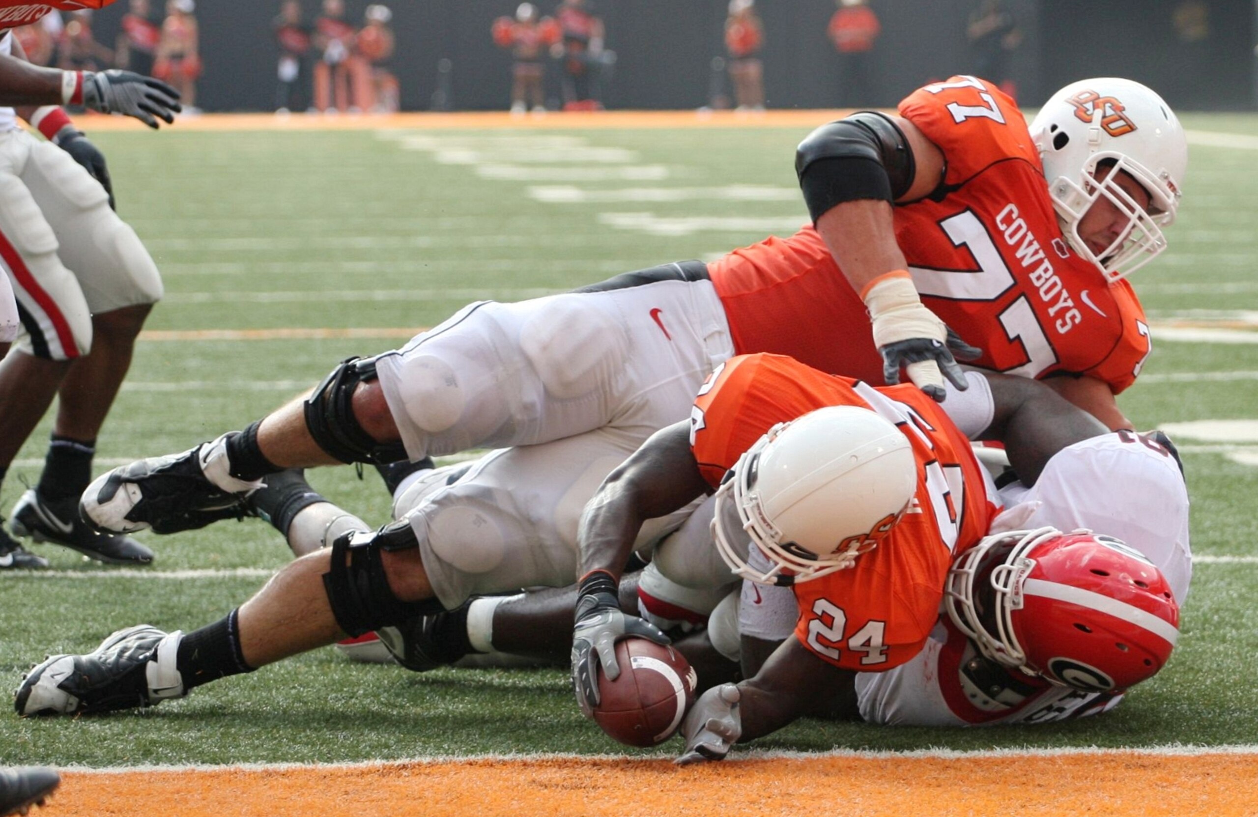 STILLWATER, OK - SEPTEMBER 5:  Running back Kendall Hunter #24 of the Oklahoma State Cowboys is stopped just short of the end zone as teammate Noah Franklin #77 falls on top during the third quarter of the game against the Georgia Bulldogs at Boone Picken