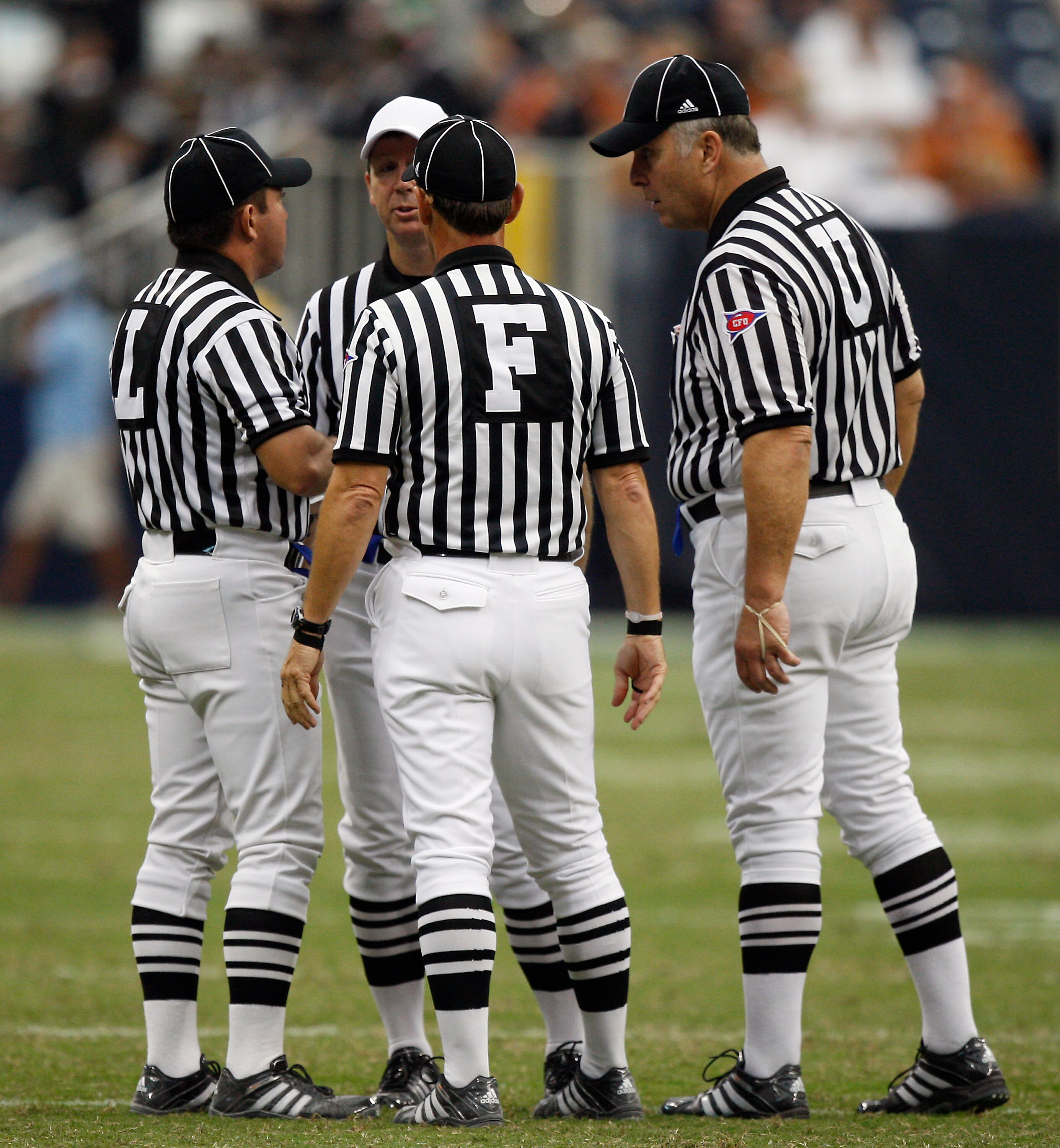 HOUSTON - SEPTEMBER 04:  The officials get together to discuss a penalty called on the play during a football game beyween the Texas Longhorns and Rice Owls at Reliant Stadium on September 4, 2010 in Houston, Texas.  (Photo by Bob Levey/Getty Images)