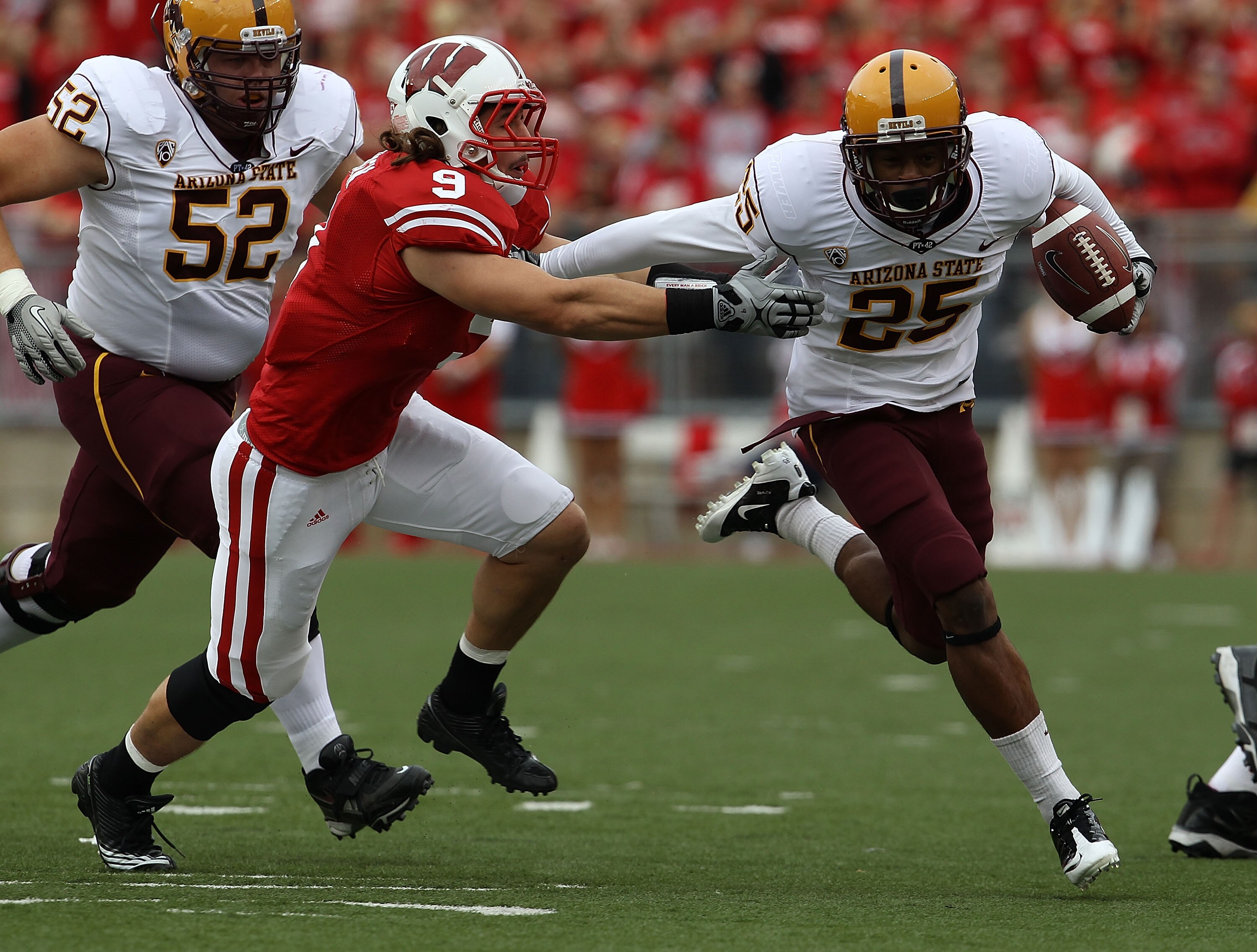 MADISON, WI - SEPTEMBER 18: Deantre Lewis #25 of the Arizona State Sun Devils tries to break away from Blake Sorensen #9 of the Wisconsin Badgers at Camp Randall Stadium on September 18, 2010 in Madison, Wisconsin. Wisconsin defeated Arizona State 20-19. 