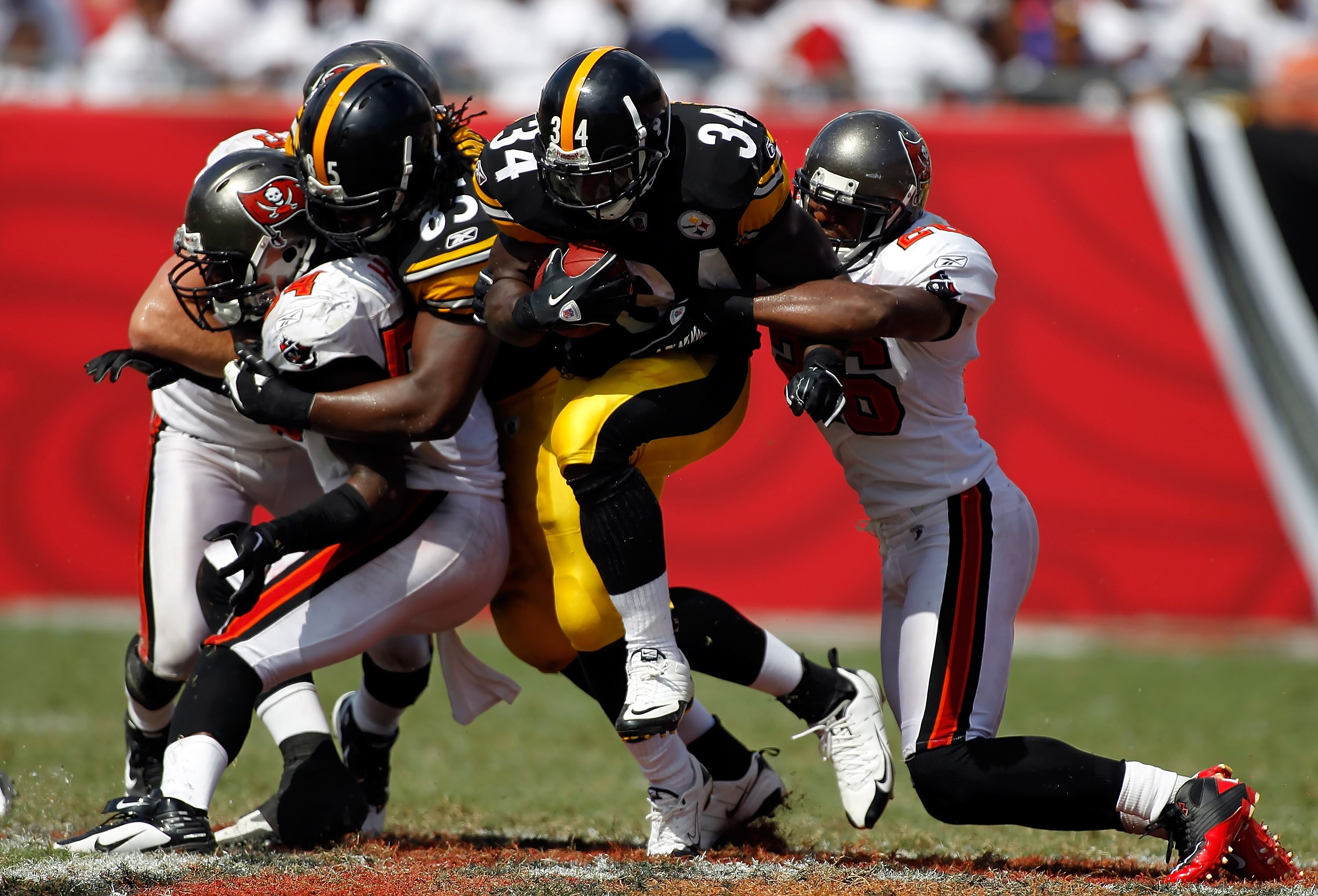 TAMPA, FL - SEPTEMBER 26:  Running back Rashard Mendenhall #34 of the Pittsburgh Steelers is tackled by safety Sean Jones #26 of the Tampa Bay Buccaneers during the game at Raymond James Stadium on September 26, 2010 in Tampa, Florida. The undefeated Stee