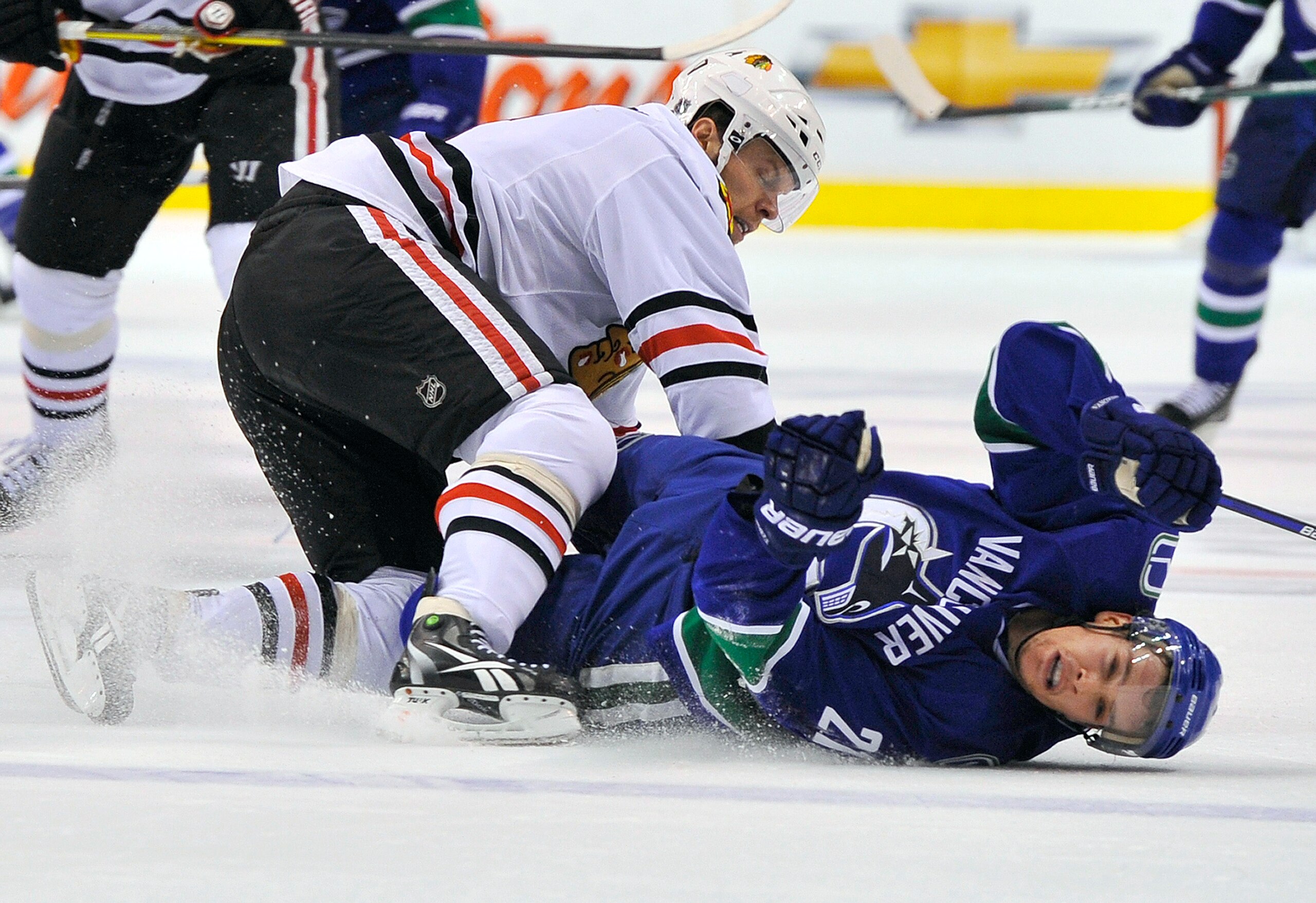 VANCOUVER, CANADA - MAY 5:  Mason Raymond #21 of the Vancouver Canucks lies on the ice after getting hit by Jordan Hendry #6 of the Chicago Blackhawks during the third period in Game Three of the Western Conference Semifinals during the 2010 NHL Stanley C