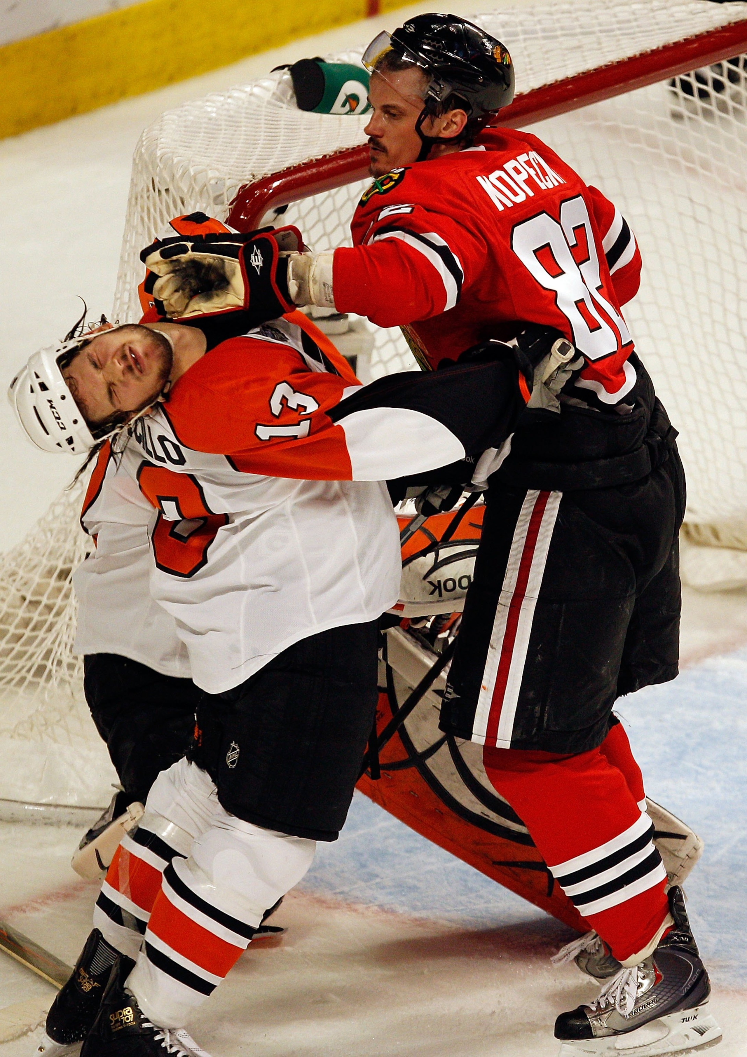 CHICAGO - MAY 31:  Tomas Kopecky #82 of the Chicago Blackhawks hits Daniel Carcillo #13 of the Philadelphia Flyers in the face in the first period of Game Two of the 2010 NHL Stanley Cup Final at the United Center on May 31, 2010 in Chicago, Illinois.  (P