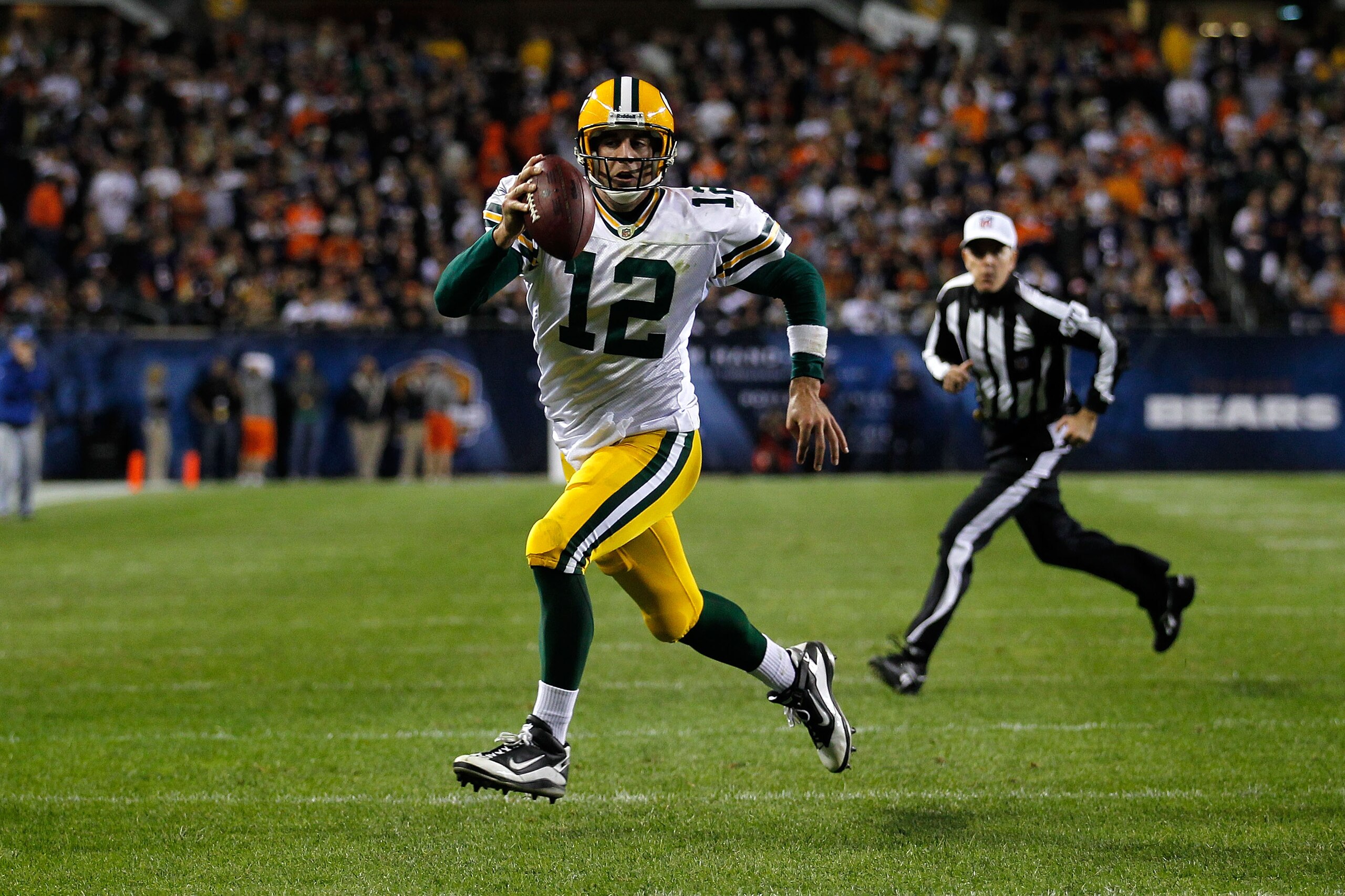 CHICAGO - SEPTEMBER 27: Aaron Rodgers #12 of the Green Bay Packers runs for a 3-yard rushing touchdown in the fourth quarter against the Chicago Bears at Soldier Field on September 27, 2010 in Chicago, Illinois. (Photo by Jonathan Daniel/Getty Images) CHICAGO - SEPTEMBER 27: Aaron Rodgers #12 of the Green Bay Packers runs for a 3-yard rushing touchdown in the fourth quarter against the Chicago Bears at Soldier Field on September 27, 2010 in Chicago, Illinois. (Photo by Jonathan Daniel/Getty Images)