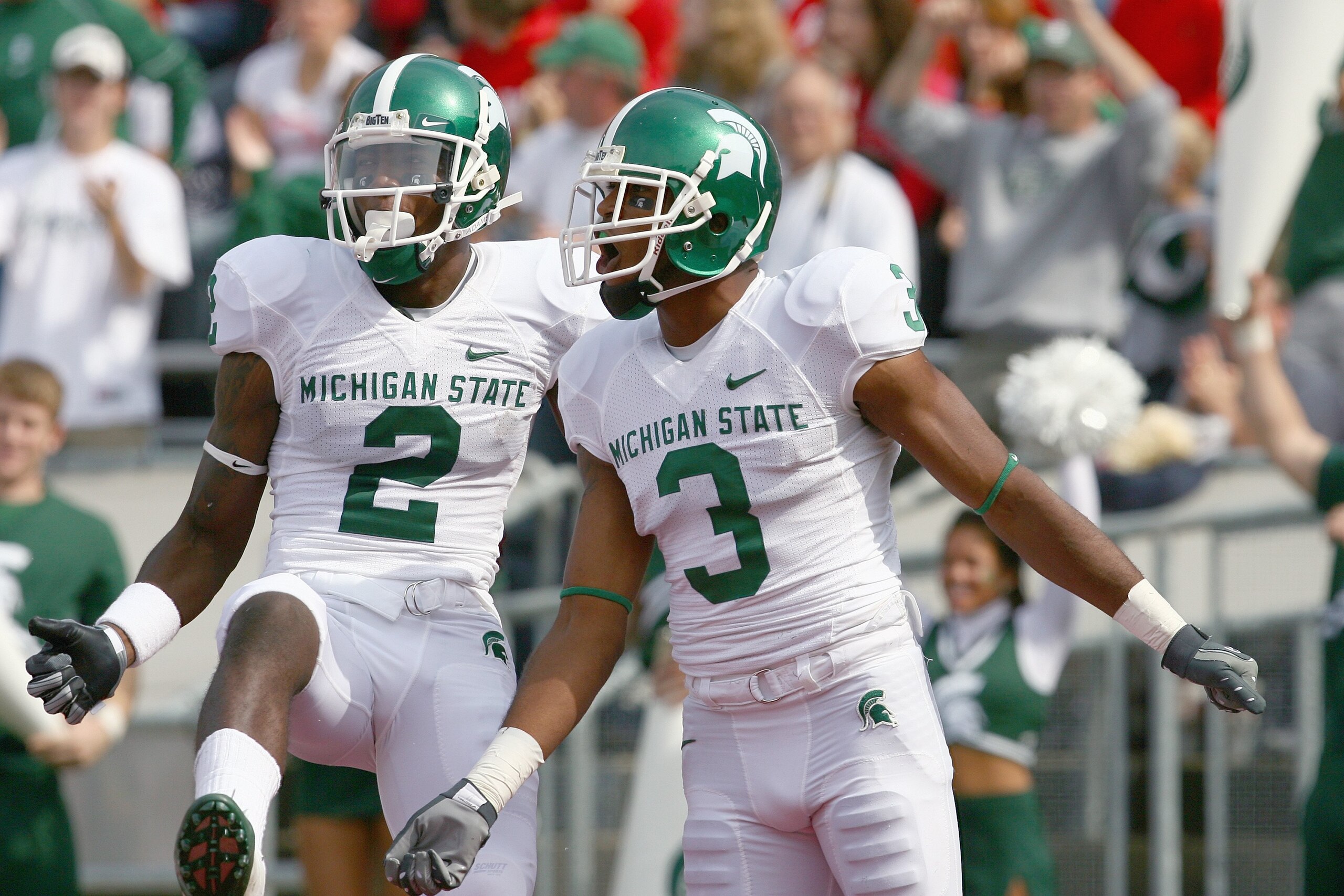 MADISON, WI - SEPTEMBER 26: B.J. Cunningham #3 and Mark Dell #2 of the Michigan State Spartans celebrate on te field against the Wisconsin Badgers on September 26, 2009 at Camp Randall Stadium in Madison, Wisconsin. (Photo by Jonathan Daniel/Getty Images)