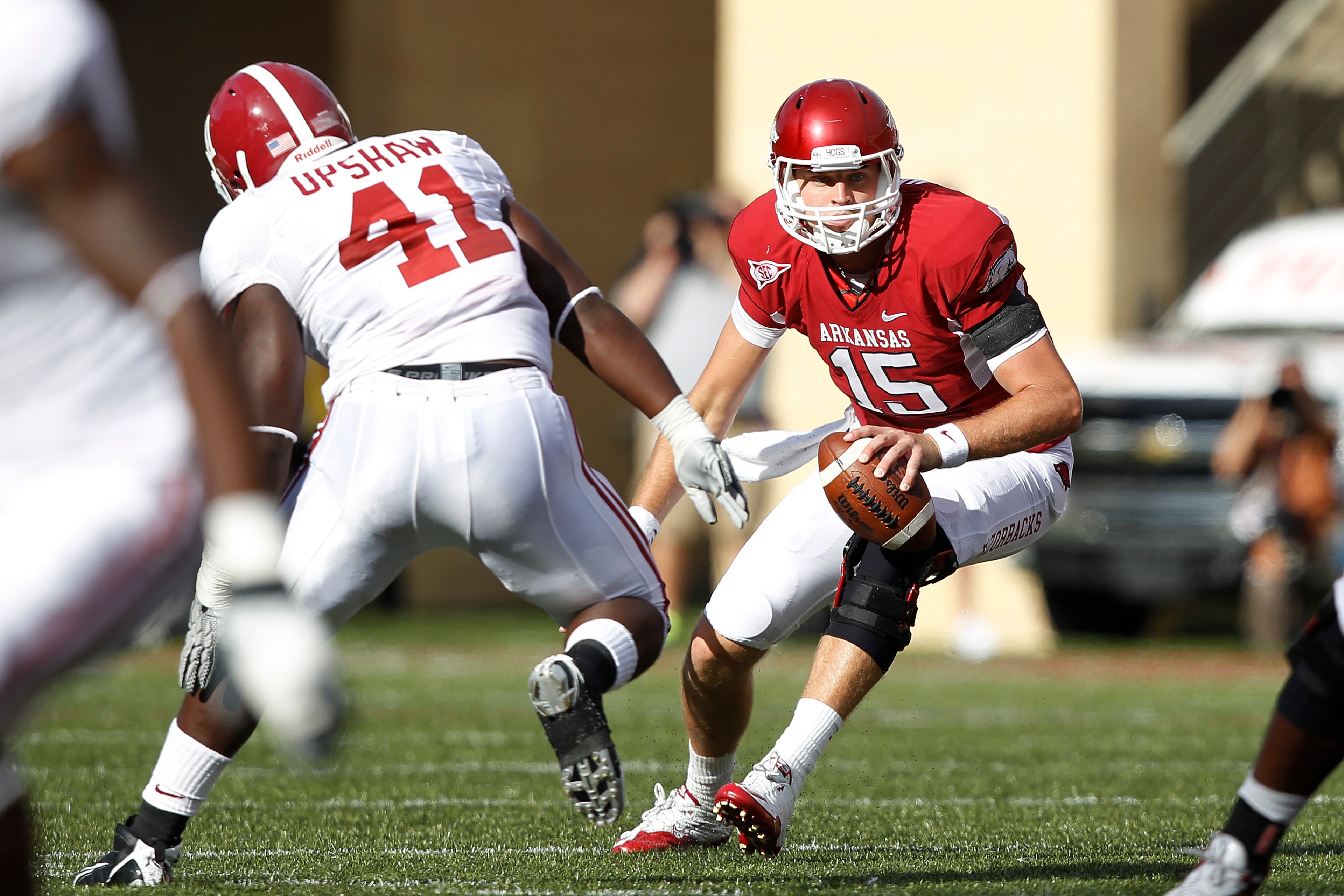 FAYETTEVILLE - SEPTEMBER 25: Ryan Mallett #15 of the Arkansas Razorbacks tries to avoid pressure from Courtney Upshaw #41 of the Alabama Crimson Tide at Donald W. Reynolds Razorback Stadium on September 25, 2010 in Fayetteville, Arkansas. Alabama won 24-2