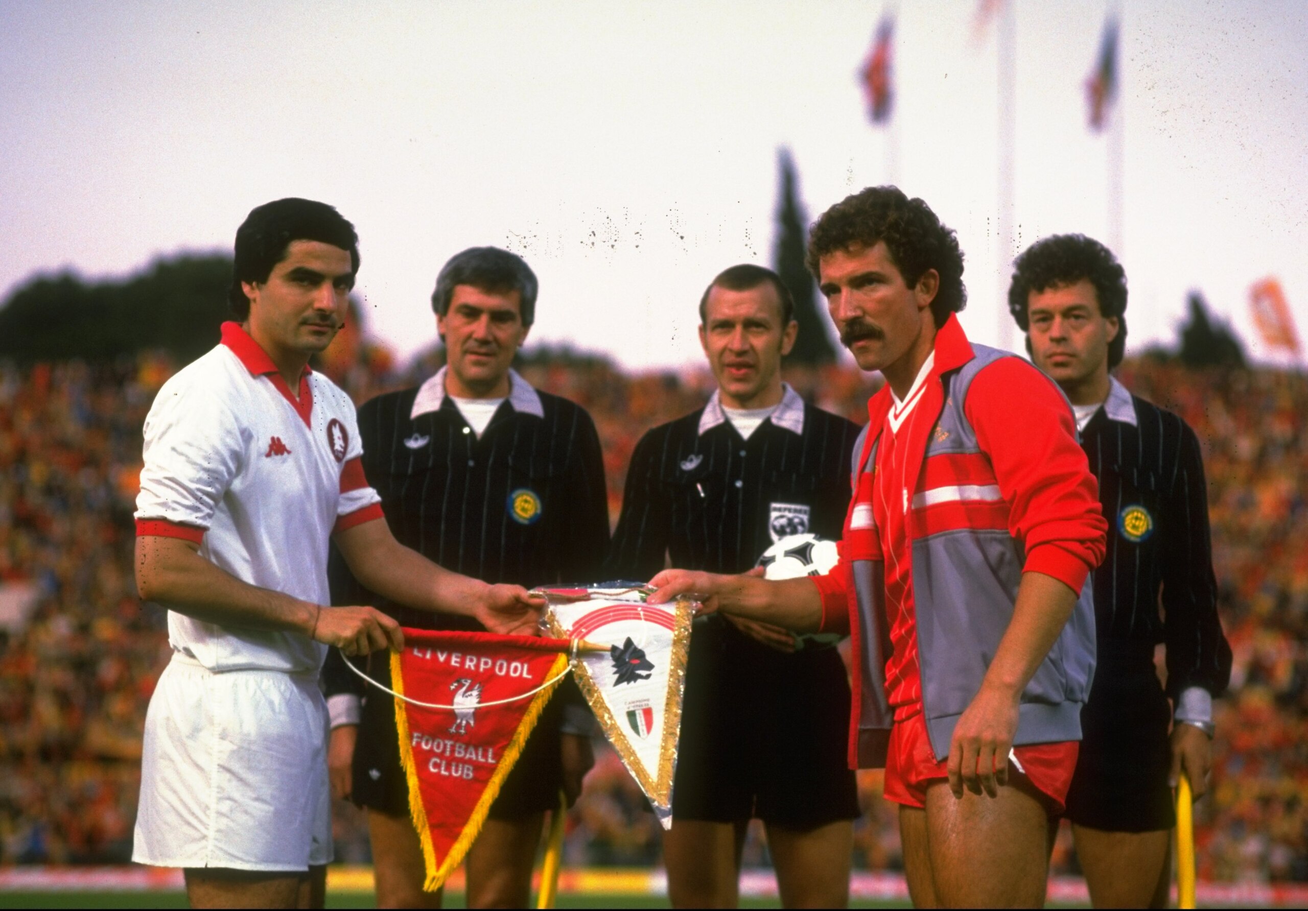30 May 1984: Di Bartolomei (left) Captain of AS Roma and Graham Souness (right) Captain of Liverpool exchange Club Pennants before the start of the European Cup Final at the Olympic Stadium in Rome. The match ended in a 1-1 draw but Liverpool won 4-2 onp 30 May 1984: Di Bartolomei (left) Captain of AS Roma and Graham Souness (right) Captain of Liverpool exchange Club Pennants before the start of the European Cup Final at the Olympic Stadium in Rome. The match ended in a 1-1 draw but Liverpool won 4-2 onp