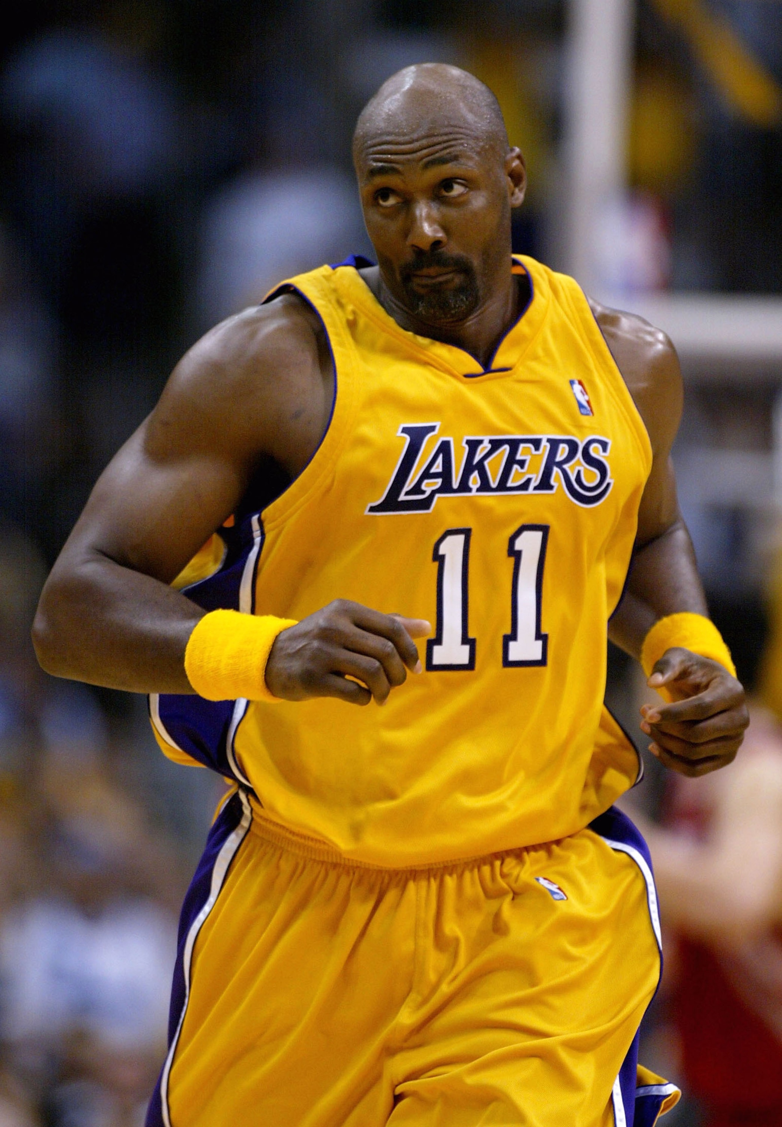 LOS ANGELES - APRIL 28: Karl Malone #11 of the Los Angeles Lakers runs upcourt during Game five of the Western Conference Quarterfinals against the Houston Rockets during the 2004 NBA Playoffs at Staples Center on April 28, 2004 in Los Angeles, Californi LOS ANGELES - APRIL 28: Karl Malone #11 of the Los Angeles Lakers runs upcourt during Game five of the Western Conference Quarterfinals against the Houston Rockets during the 2004 NBA Playoffs at Staples Center on April 28, 2004 in Los Angeles, Californi