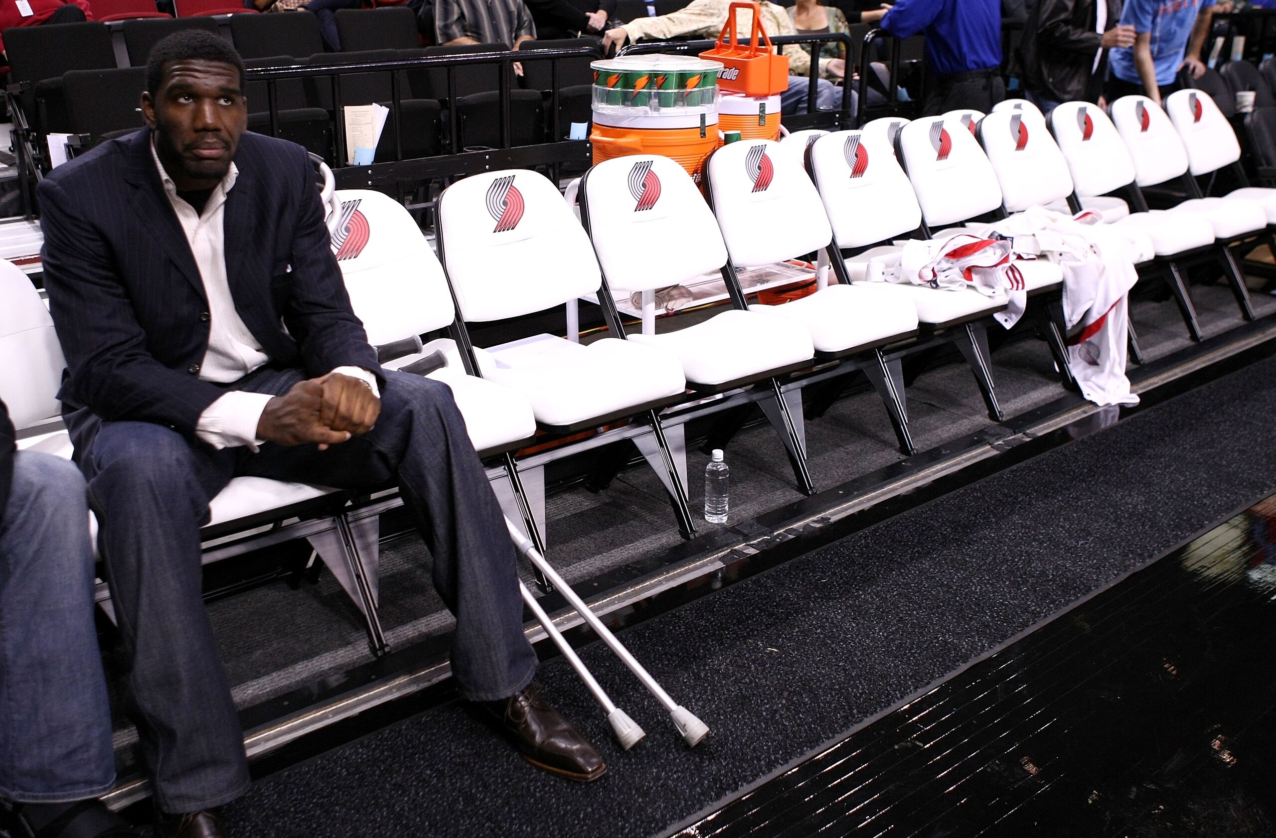 PORTLAND, OR - OCTOBER 10:  Greg Oden #52 of the Portland Trail Blazers, who is out for the season after under going micro fracture surgery in his knee, sits on the bench to watch a pre-season game against the Los Angeles Clippers at the Rose Garden on Oc