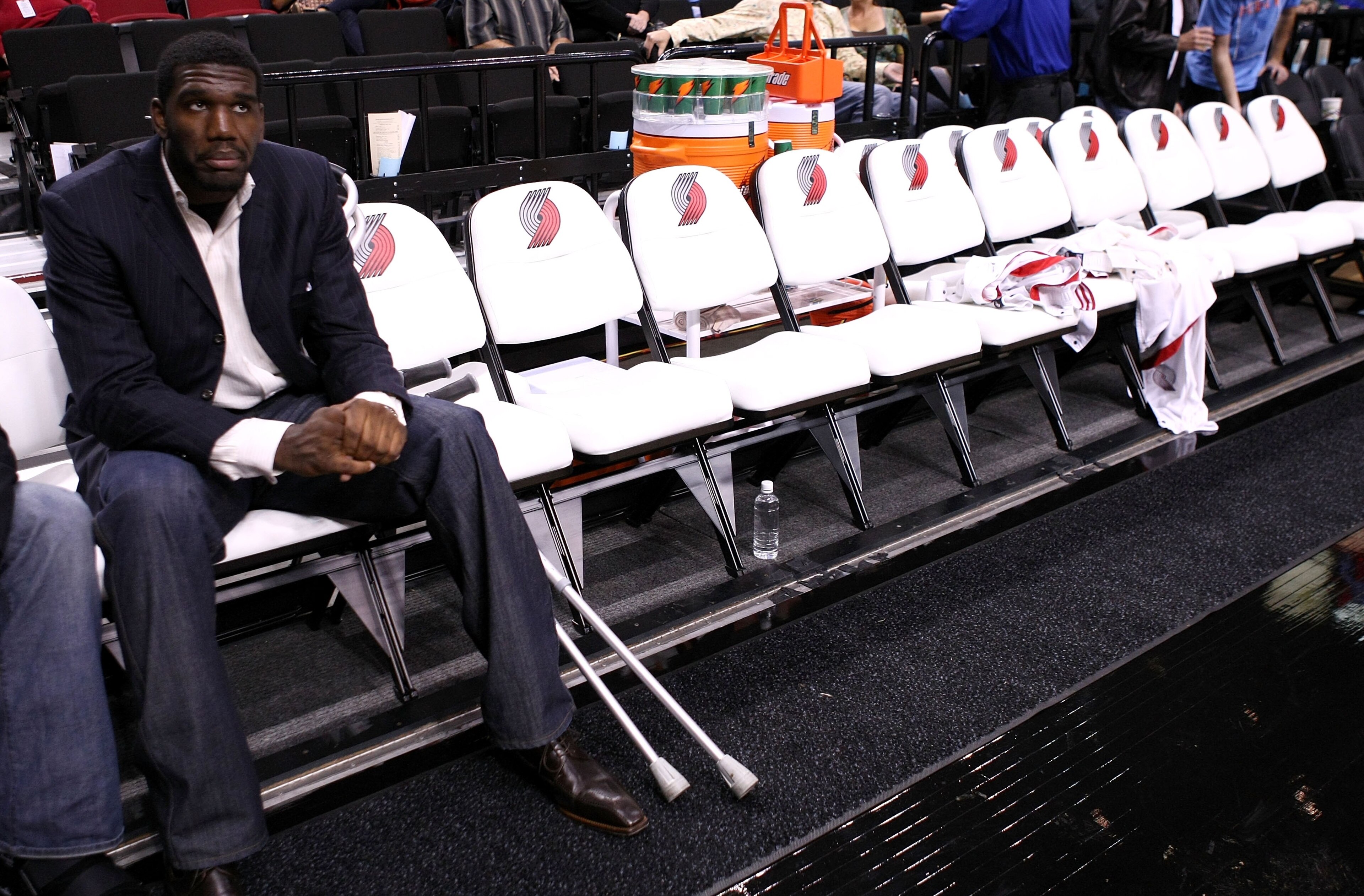 PORTLAND, OR - OCTOBER 10:  Greg Oden #52 of the Portland Trail Blazers, who is out for the season after under going micro fracture surgery in his knee, sits on the bench to watch a pre-season game against the Los Angeles Clippers at the Rose Garden on Oc