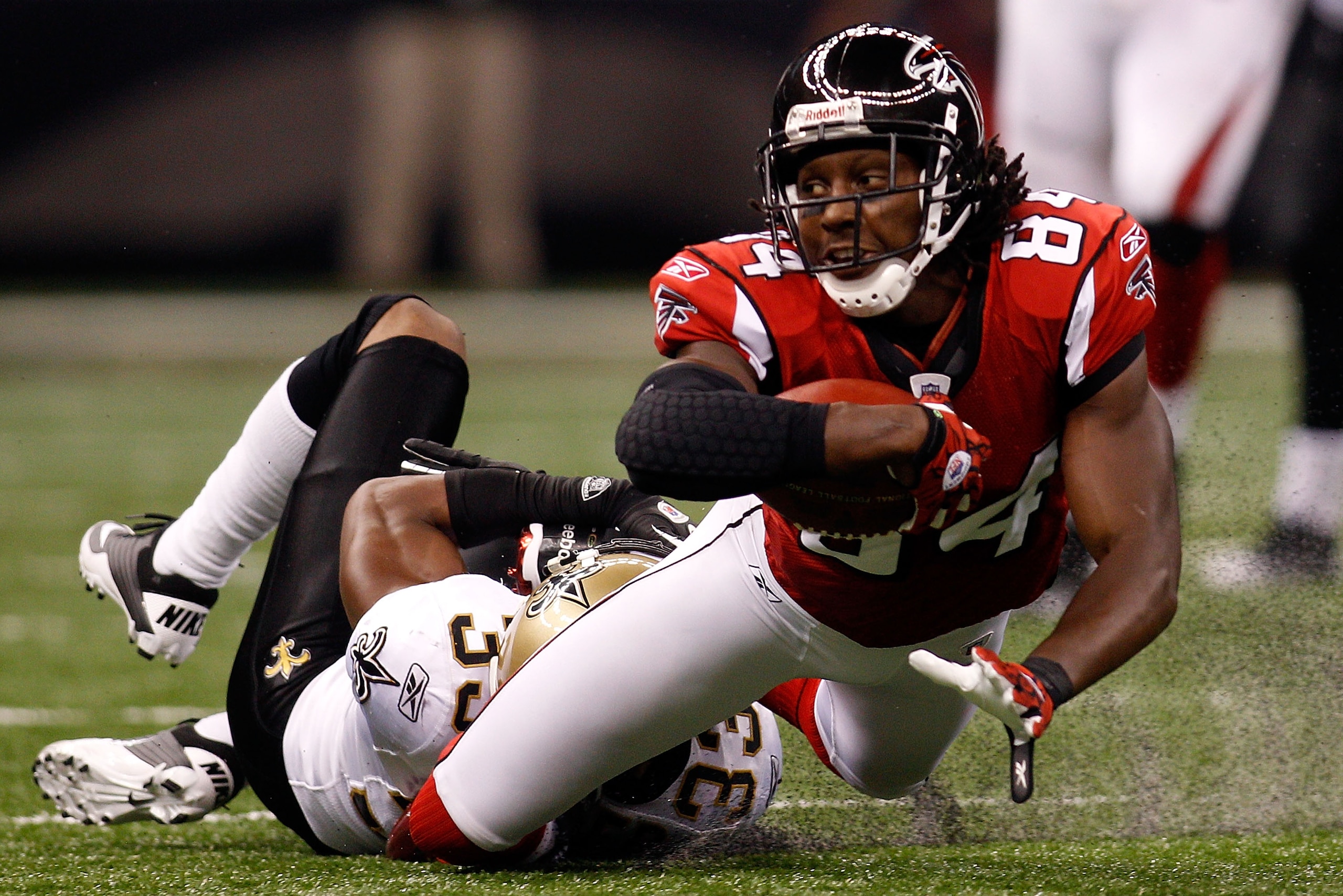 NEW ORLEANS - SEPTEMBER 26:  Roddy White #84 of the Atlanta Falcons is tackled by Jabari Greer #33 of the New Orleans Saints at the Louisiana Superdome on September 26, 2010 in New Orleans, Louisiana.  The Falcons defeated the Saints 27-24.  (Photo by Chr