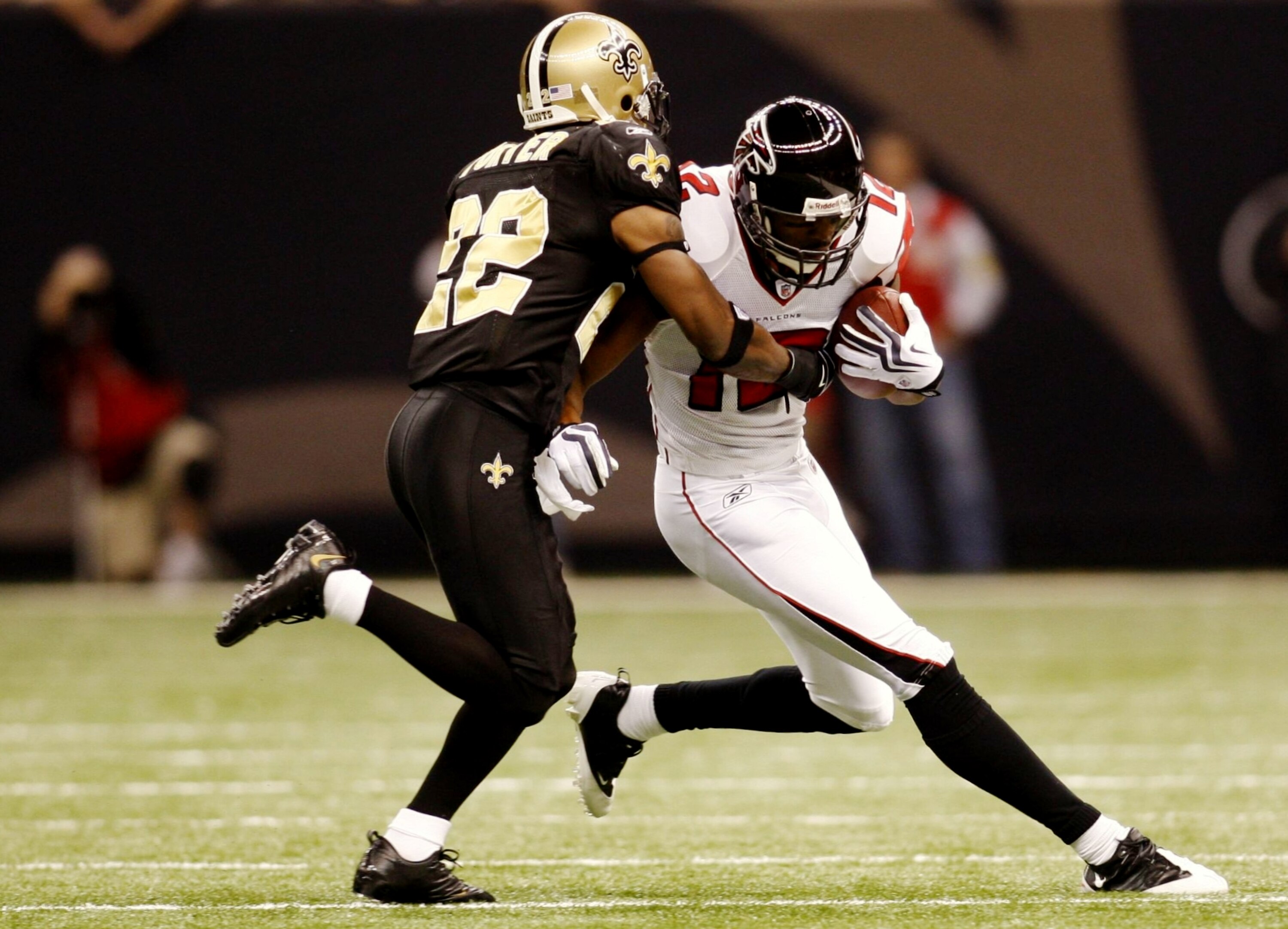 NEW ORLEANS - NOVEMBER 2:  Tracy Porter #22 of the New Orleans Saints stops Michael Jenkins #21 of the Atlanta Falcons during the game at the Louisiana Superdome on November 2, 2009 in New Orleans, Louisiana. (Photo by Chris Graythen/Getty Images)