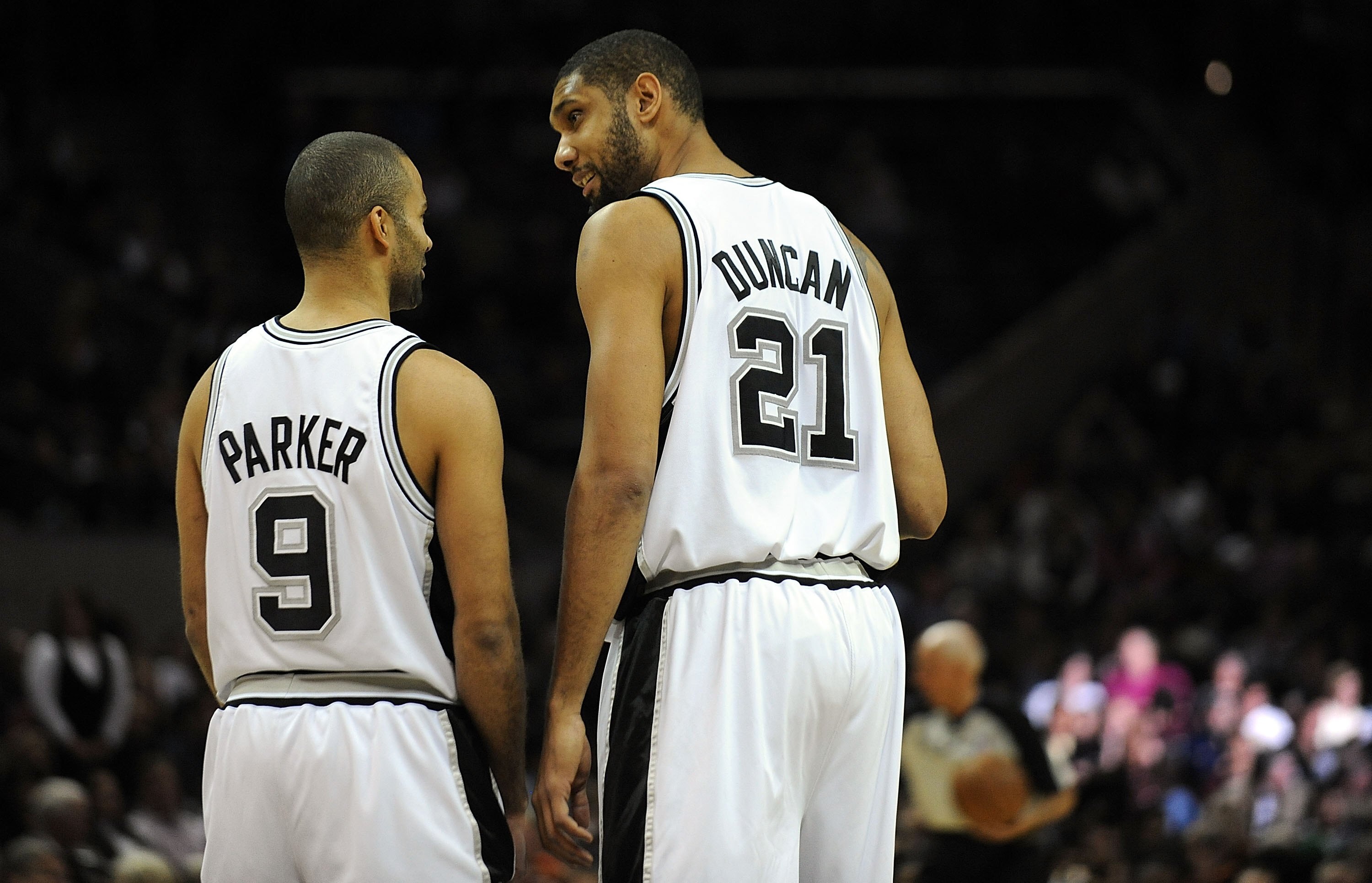 SAN ANTONIO - DECEMBER 03:  Tony Parker #9 and Tim Duncan #21 of the San Antonio Spurs before a game against the Boston Celtics on December 3, 2009 at AT&T Center in San Antonio, Texas.  NOTE TO USER: User expressly acknowledges and agrees that, by downlo
