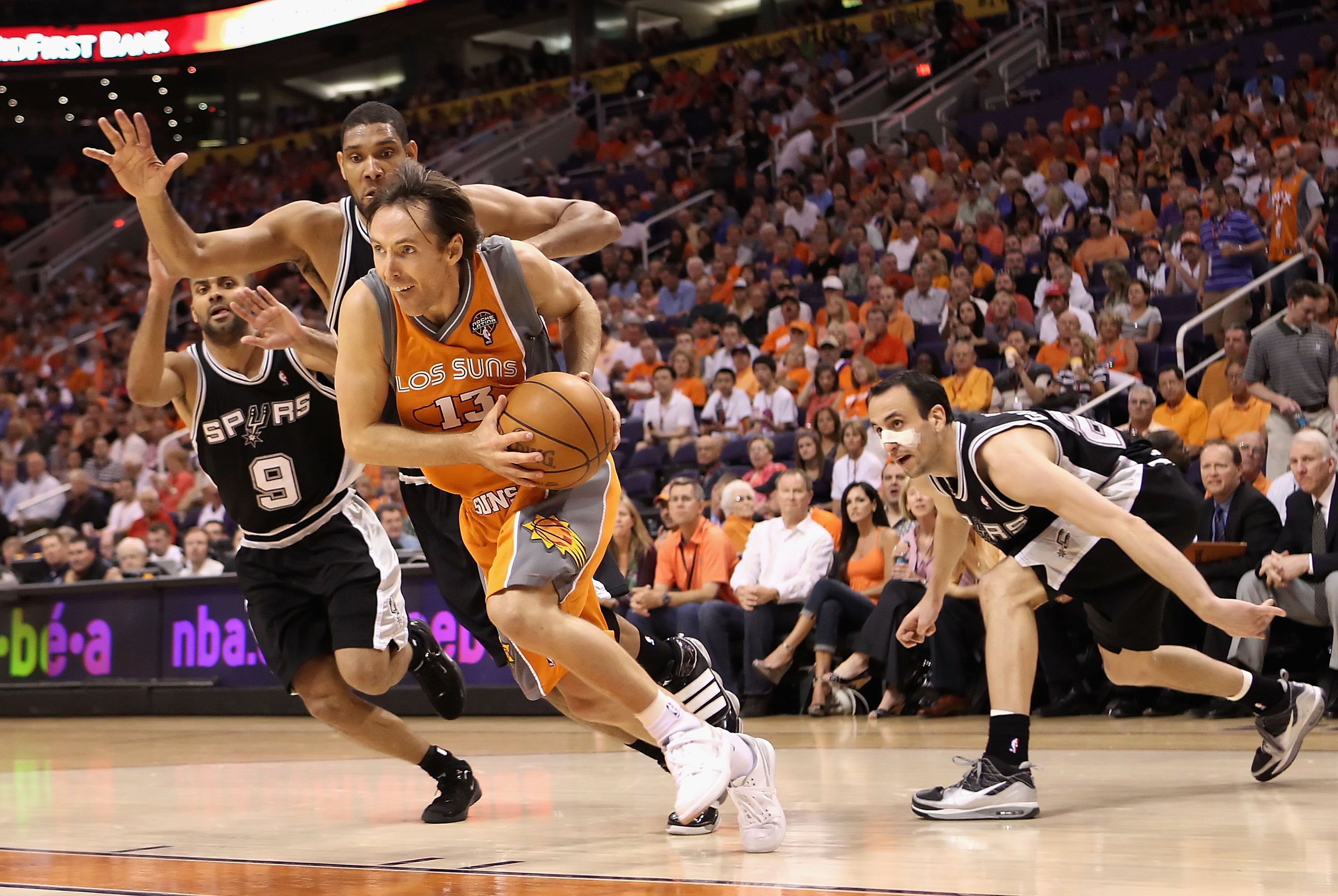 PHOENIX - MAY 05:  Steve Nash #13 of the Phoenix Suns drives the ball past Tony Parker #9, Tim Duncan #21 and Manu Ginobili #20 of the San Antonio Spurs during Game Two of the Western Conference Semifinals of the 2010 NBA Playoffs at US Airways Center on