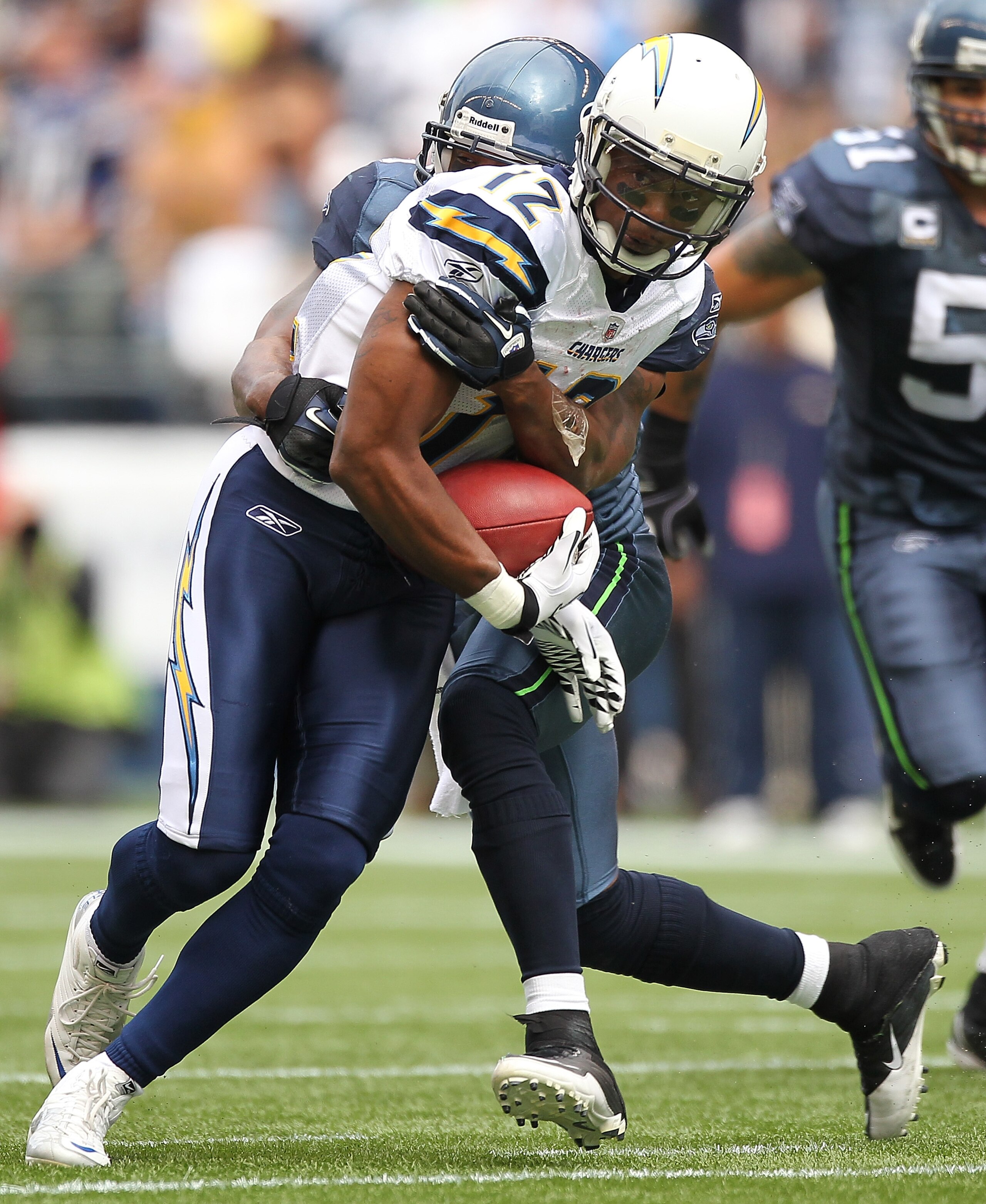 SEATTLE - SEPTEMBER 26:  Wide receiver Patrick Crayton #12 of the San Diego Chargers rushes against Lawyer Milloy #36 of the Seattle Seahawks at Qwest Field on September 26, 2010 in Seattle, Washington. (Photo by Otto Greule Jr/Getty Images)