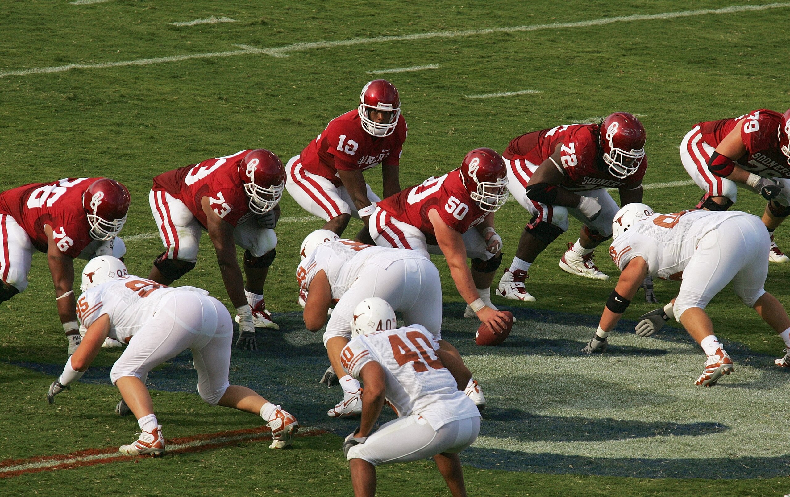 DALLAS - OCTOBER 7:  Quarterback Paul Thompson #12 of the Oklahoma Sooners calls the signals as center Jon Cooper #50 and the line wait for the snap during the Red River Shootout against the Texas Longhorns at the Cotton Bowl on October 7, 2006 in Dallas,