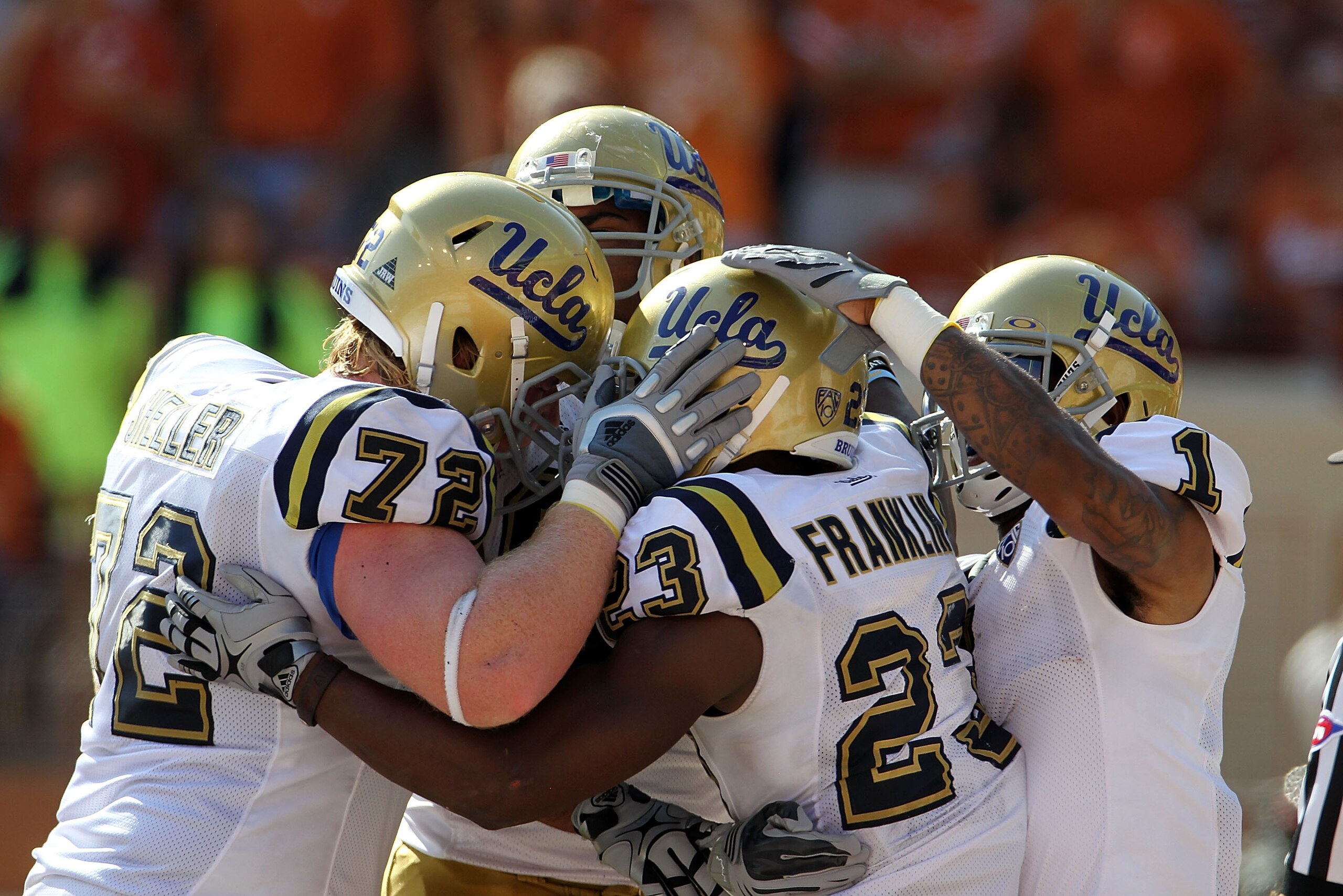 AUSTIN, TX - SEPTEMBER 25:  Tailback Johnathan Franklin #23 of the UCLA Bruins celebrates a touchdown with Cory Harkey #87 and Randall Carroll #1 in the third quarter against the Texas Longhorns at Darrell K Royal-Texas Memorial Stadium on September 25, 2