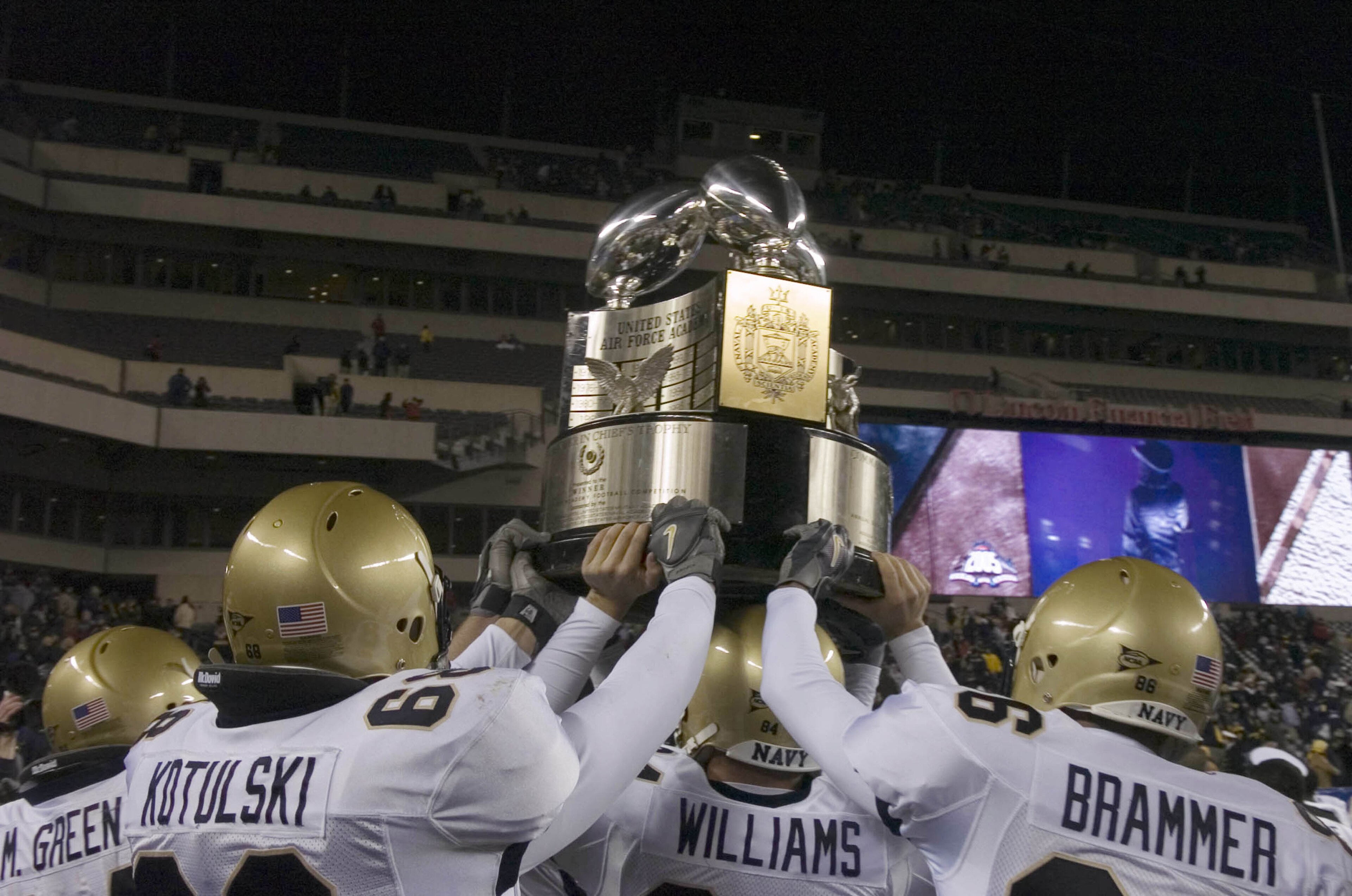 PHILADELPHIA - DECEMBER 3:  In this handout provided by the U.S. Navy, Navy players hold the Commander-in-Chief's Trophy following a 42-23 victory over the Black Knights of Army in the 106th Army vs. Navy football game on December 3, 2005 held for the thi