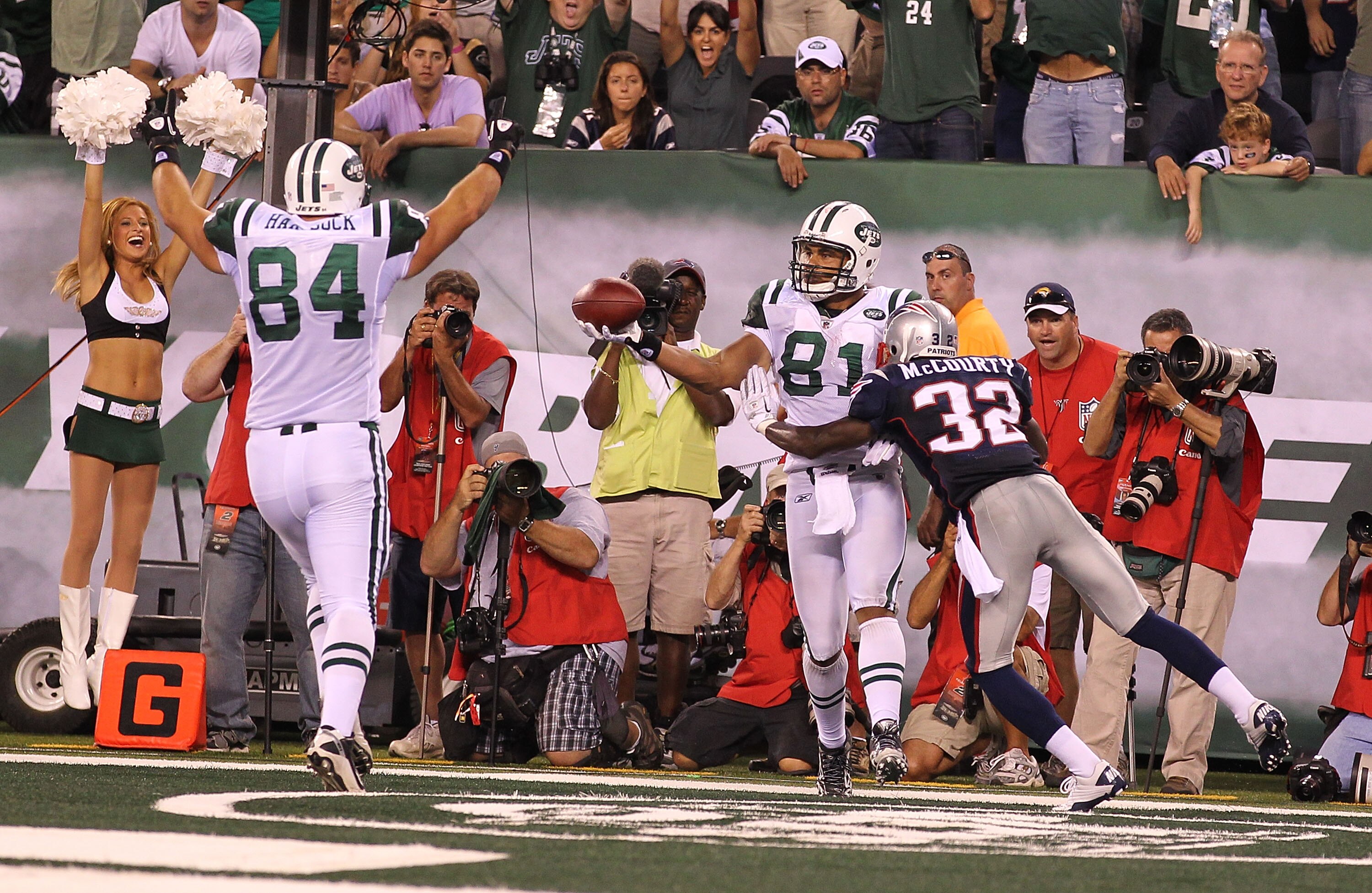 EAST RUTHERFORD, NJ - SEPTEMBER 19:  Dustin Keller #81 of the New York Jets scores a touchdown as Devin McCourty #32 of the New England Patriots defends during their  game on September 19, 2010 at the New Meadowlands Stadium  in East Rutherford, New Jerse