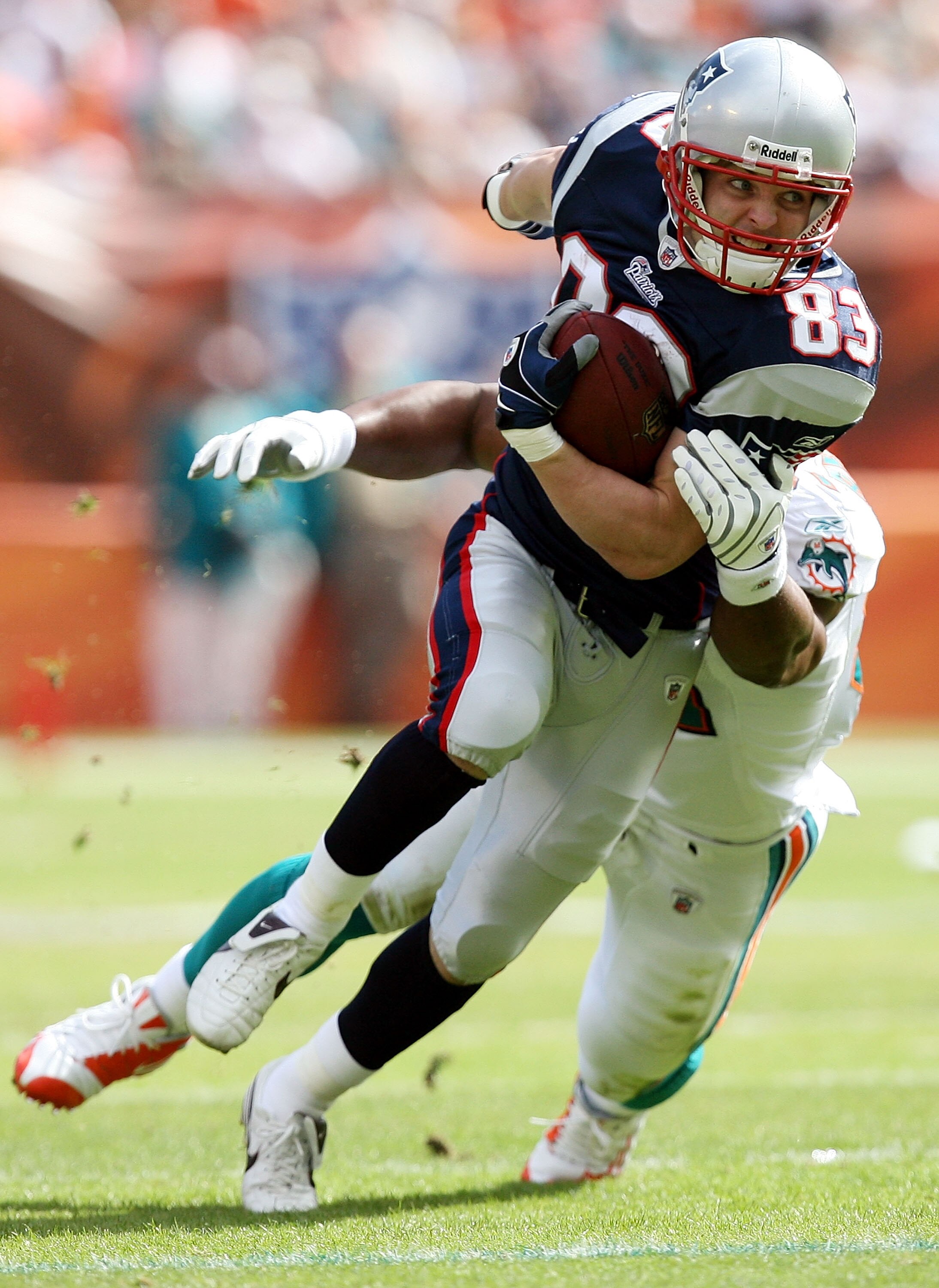 MIAMI - NOVEMBER 23:  Wide receiver Wes Welker #83 of the New England Patriots breaks free from a tackle attempt by linebacker Akin Ayodele #51 of the Miami Dolphins at Dolphin Stadium on November 23, 2008 in Miami, Florida.  (Photo by Doug Benc/Getty Ima