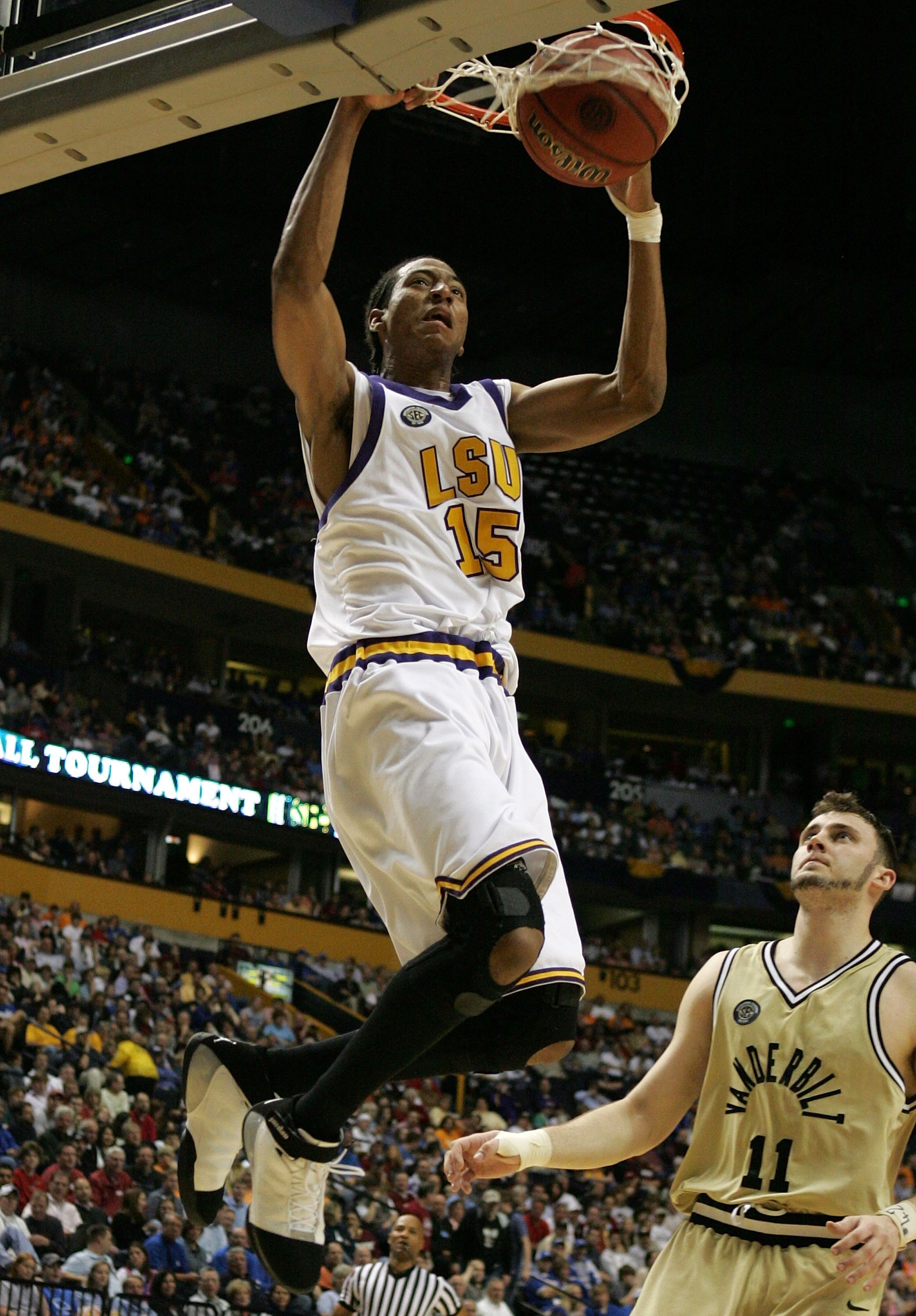 NASHVILLE, TN - MARCH 10:  Magnum Rolle #15 of the LSU Tigers dunks against Alan Metcalfe #11 of the Vanderbilt Commodores during day 2 of the SEC Men's Basketball Conference Tournament March 10, 2006 at the Gaylord Entertainment Center in Nashville, Tenn