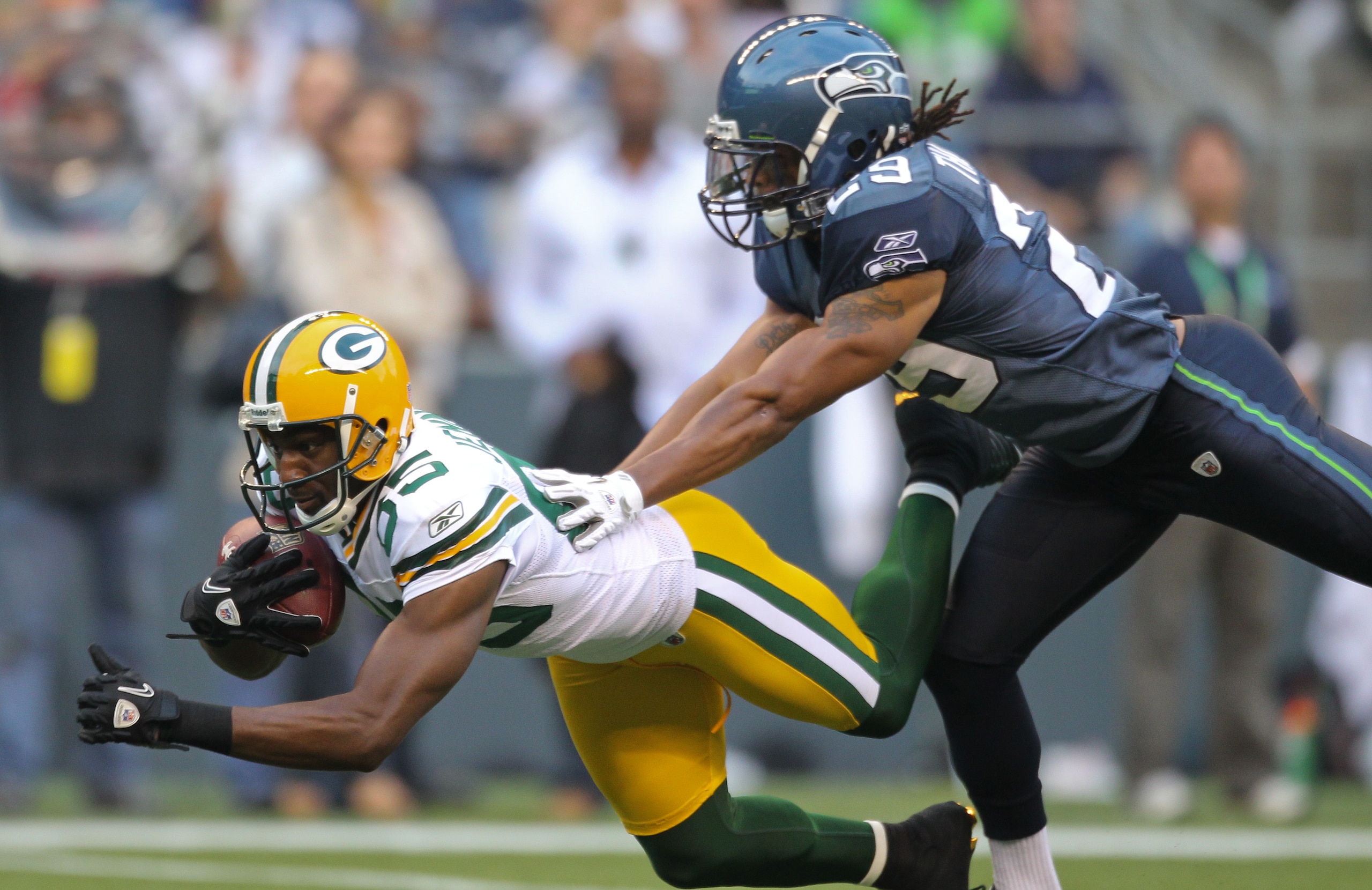 SEATTLE - AUGUST 21:  Wide receiver Greg Jennings #85 of the Green Bay Packers makes a catch during the preseason game against Earl Thomas #29 of the Seattle Seahawks at Qwest Field on August 21, 2010 in Seattle, Washington. (Photo by Otto Greule Jr/Getty
