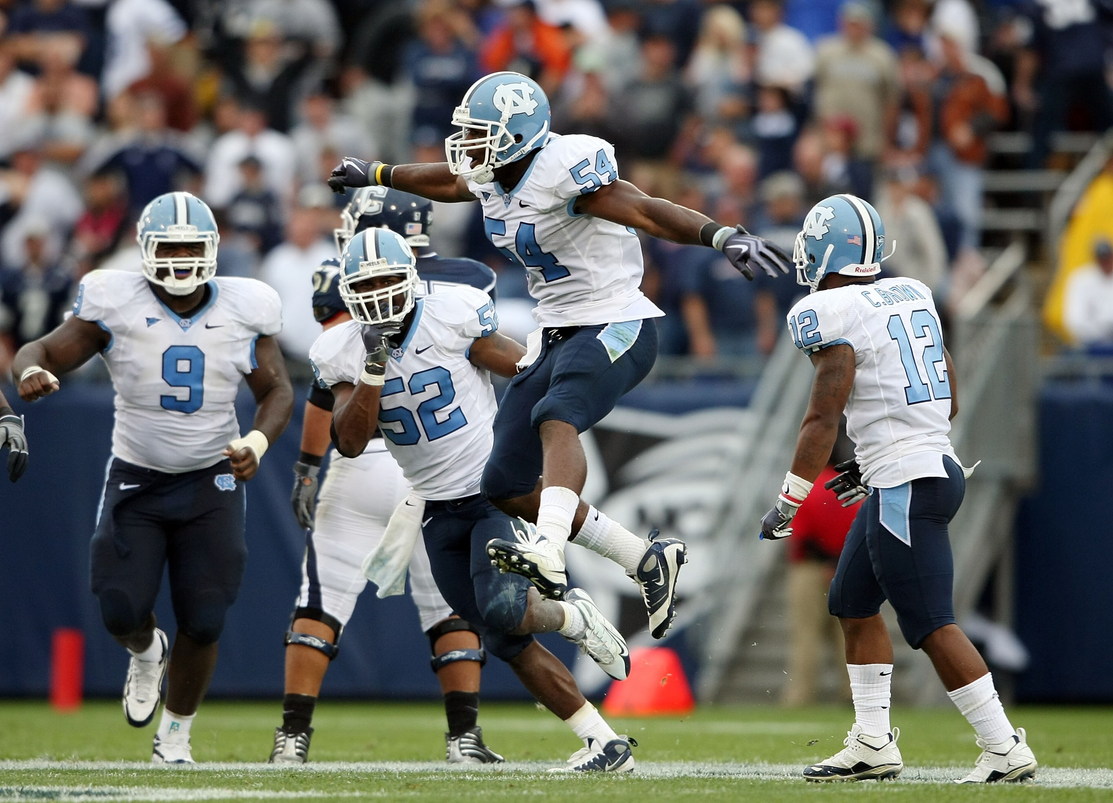 EAST HARTFORD, CT - SEPTEMBER 12:  Bruce Carter #54 of the North Carolinia Tar Heels celebrates his sack with teammates Melvin Williams #10, Marvin Austin #9 and Quan Sturdivant #52 in the final minute of the game against the Connecticut Huskies on Septem