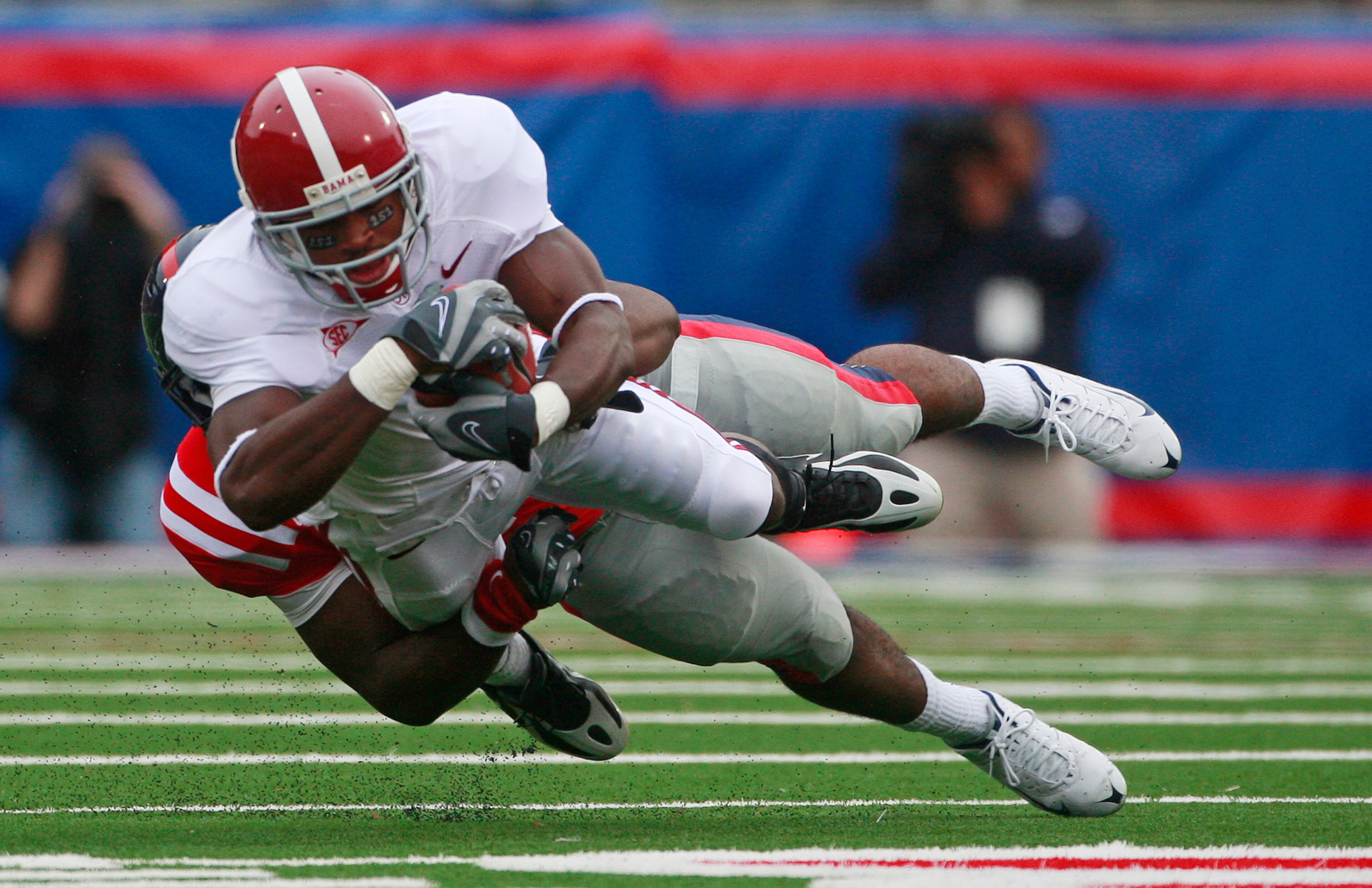 OXFORD, MS - OCTOBER 10:  Mark Baron #4 of the Alabama Crimson Tide runs for a first down on a fake punt as Joel Kight #49 of the Mississippi Rebels defens during their college football game at Vaught-Hemingway Stadium on October 10, 2009 in Oxford, Missi