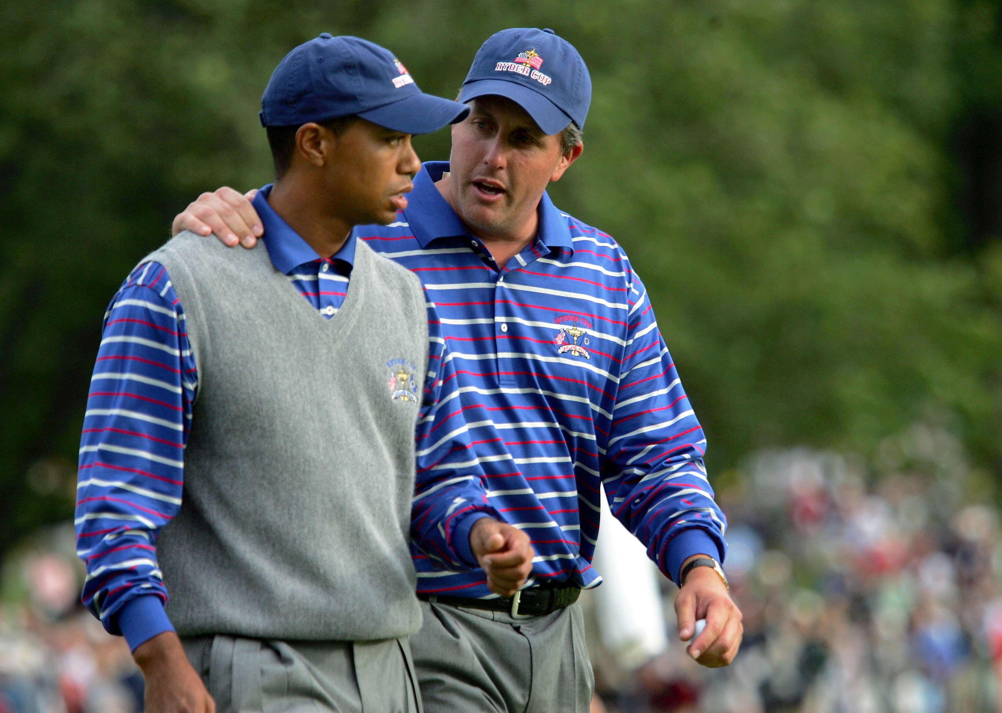 BLOOMFIELD TOWNSHIP, MI - SEPTEMBER 17: USA team players Tiger Woods and Phil Mickelson walk off the 18th green during their afternoon foursome match against Darren Clarke and Lee Westwood of Europe at the 35th Ryder Cup Matches at the Oakland Hills Count