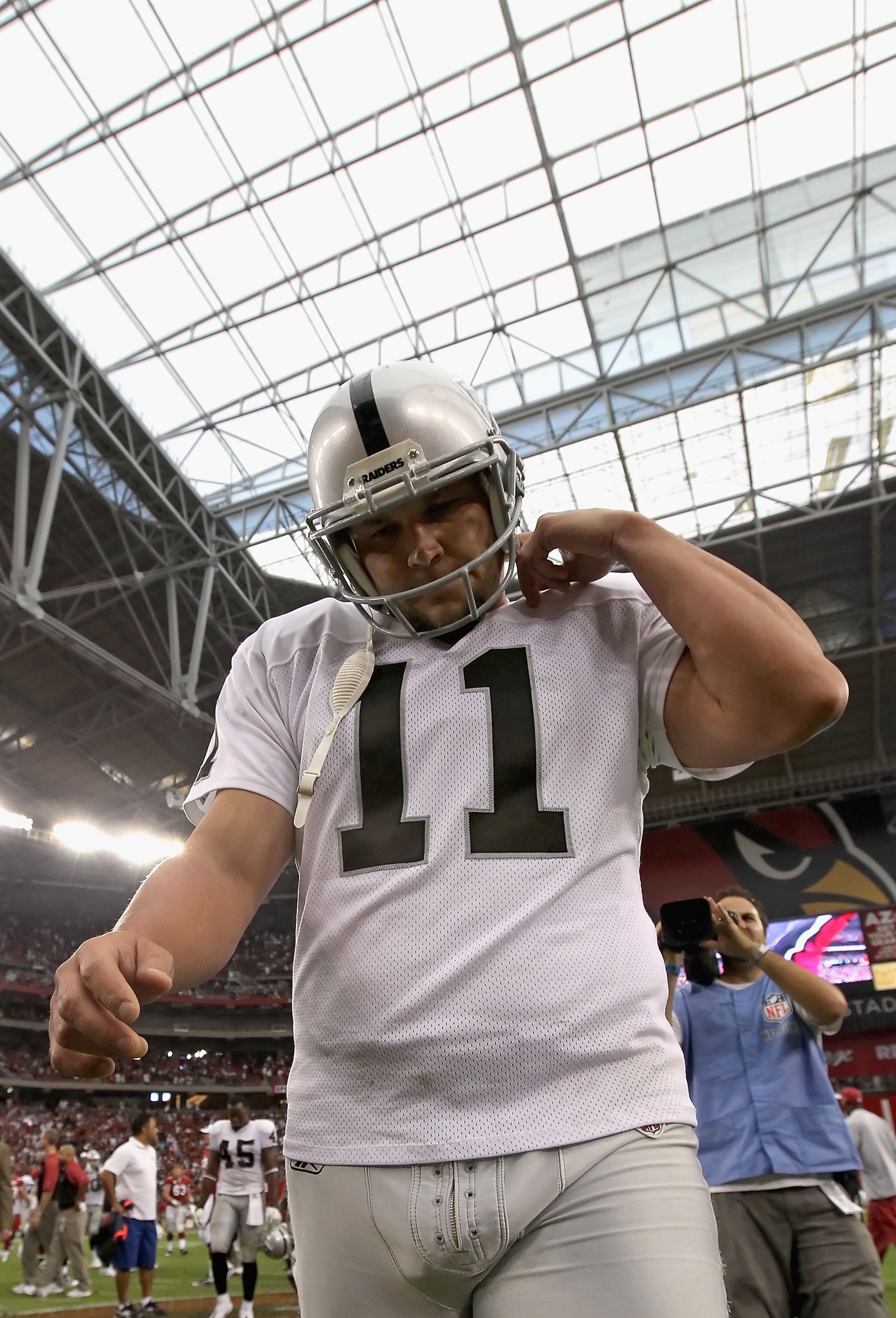 GLENDALE, AZ - SEPTEMBER 26:  Kicker Sebastian Janikowski #11 of the Oakland Raiders walks off the field after missing the game winning 32 yard field goal against the Arizona Cardinals during the NFL game at the University of Phoenix Stadium on September 