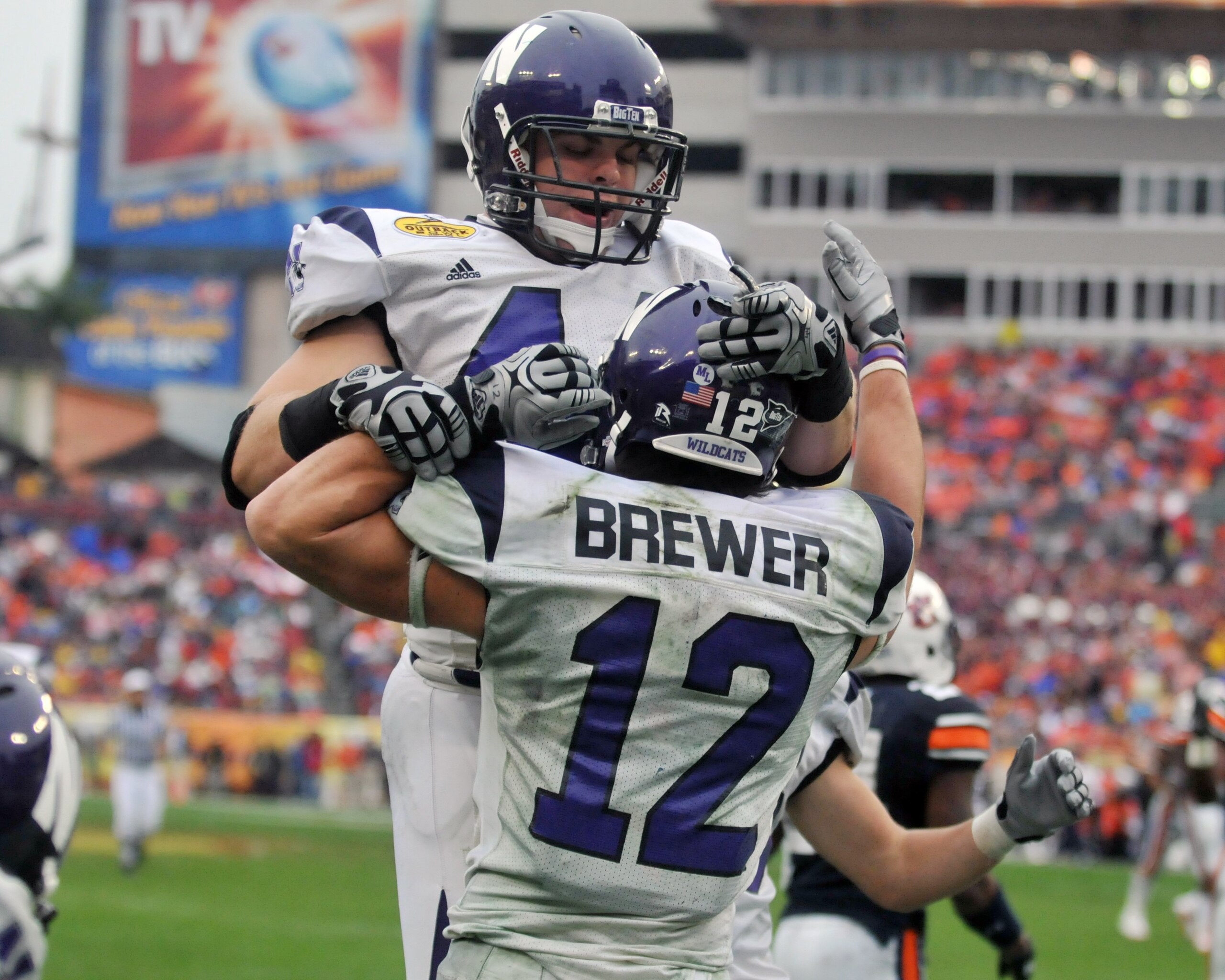 TAMPA, FL - JANUARY 1: Wide receiver Andrew Brewer #12 of the Northwestern Wildcats celebrates a touchdown pass with split back Mark Woodsum #44 against the Auburn Tigers in the Outback Bowl January 1, 2010 at Raymond James Stadium in Tampa, Florida.  (Ph