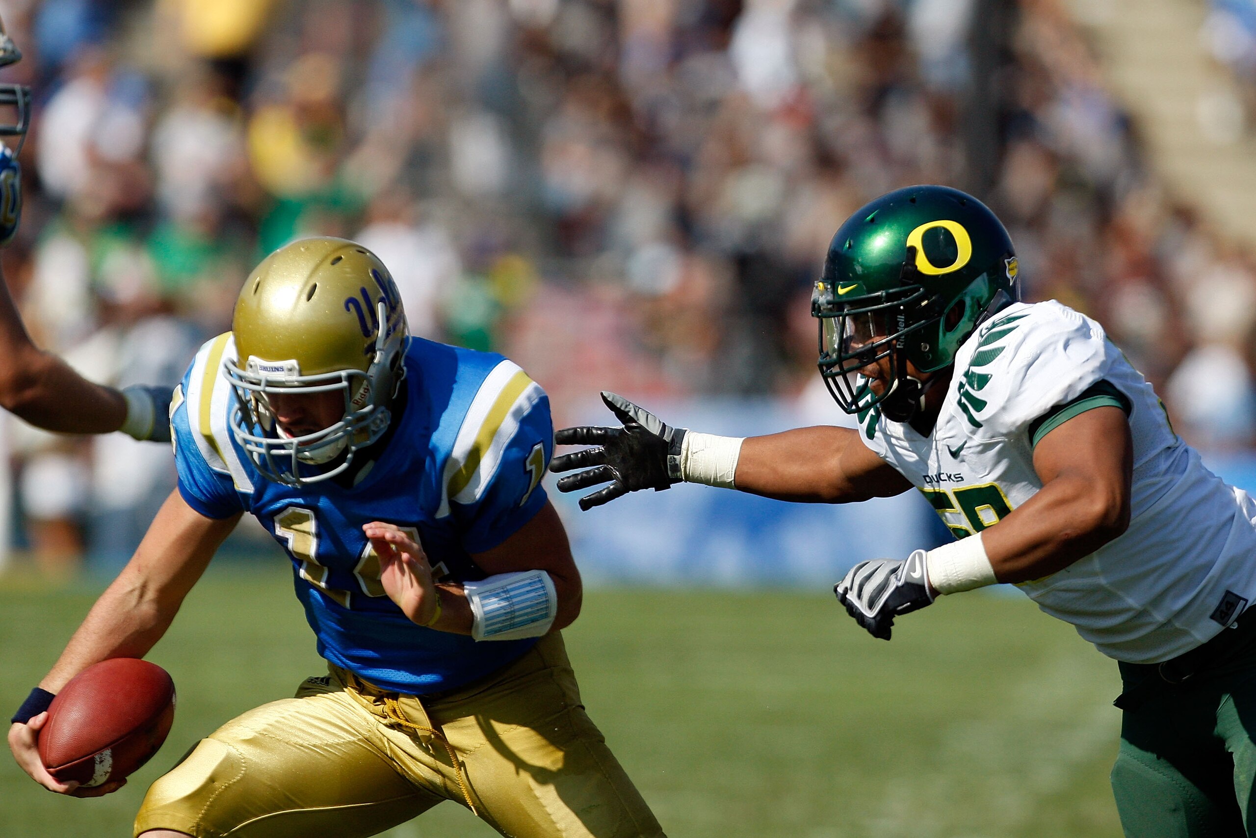 PASADENA, CA. - OCTOBER 10: Kevin Prince #14 of the UCLA Bruins gets sacked by Kenny Rowe #58 of the Oregon Ducks in the second quarter on October 10, 2009 at the Rosebowl in Pasadena, California. The Ducks defeated the Bruins 24-10  (Photo by Jacob De go