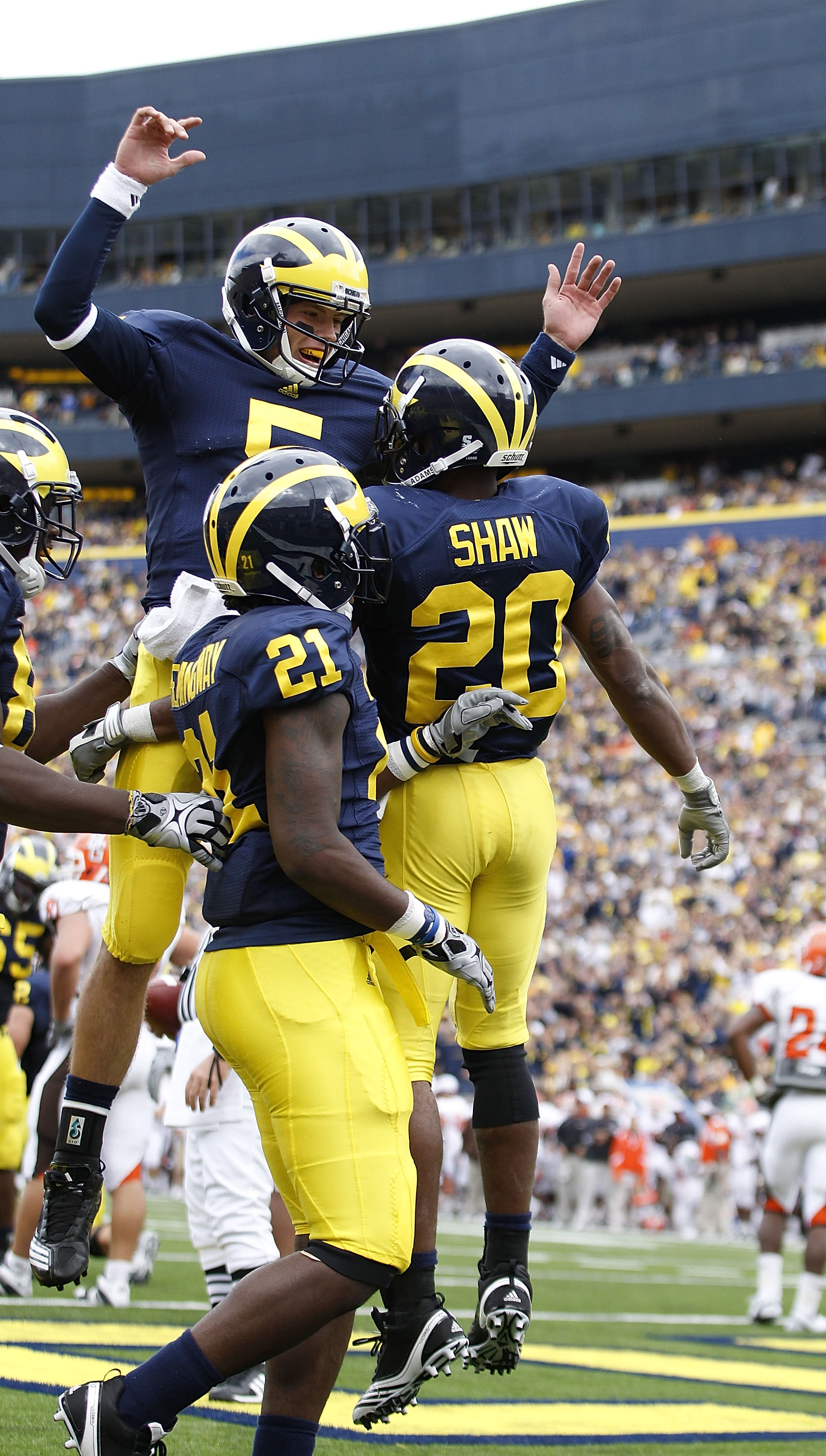 ANN ARBOR, MI - SEPTEMBER 25:  Tate Forcier #5 and Michael Shaw #20 of the Michigan Wolverines celebrate a second quarter touchdown during the game against Bowling Green on September 25, 2010 at Michigan Stadium in Ann Arbor, Michigan. Michigan defeated B