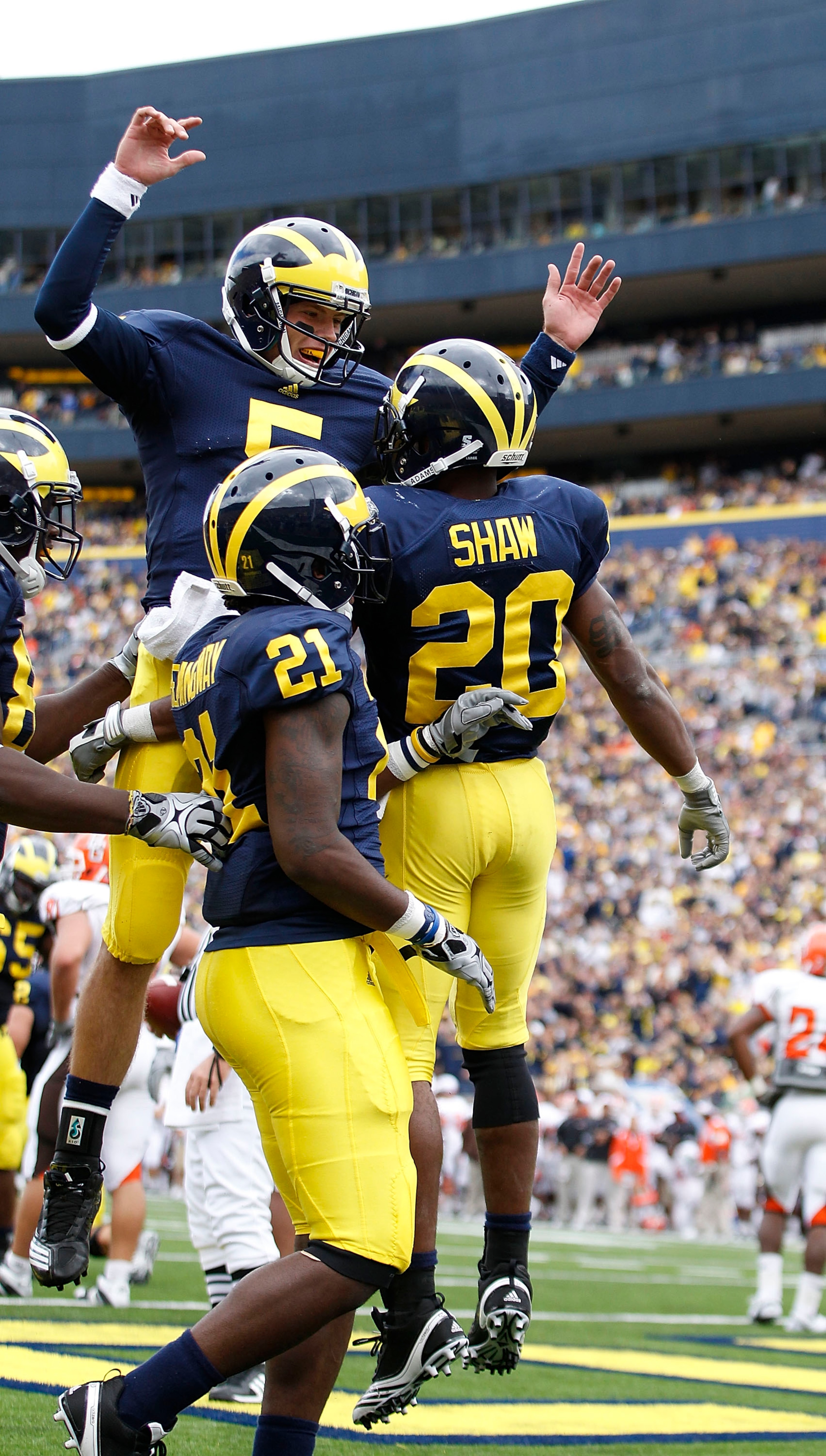 ANN ARBOR, MI - SEPTEMBER 25:  Tate Forcier #5 and Michael Shaw #20 of the Michigan Wolverines celebrate a second quarter touchdown during the game against Bowling Green on September 25, 2010 at Michigan Stadium in Ann Arbor, Michigan. Michigan defeated B
