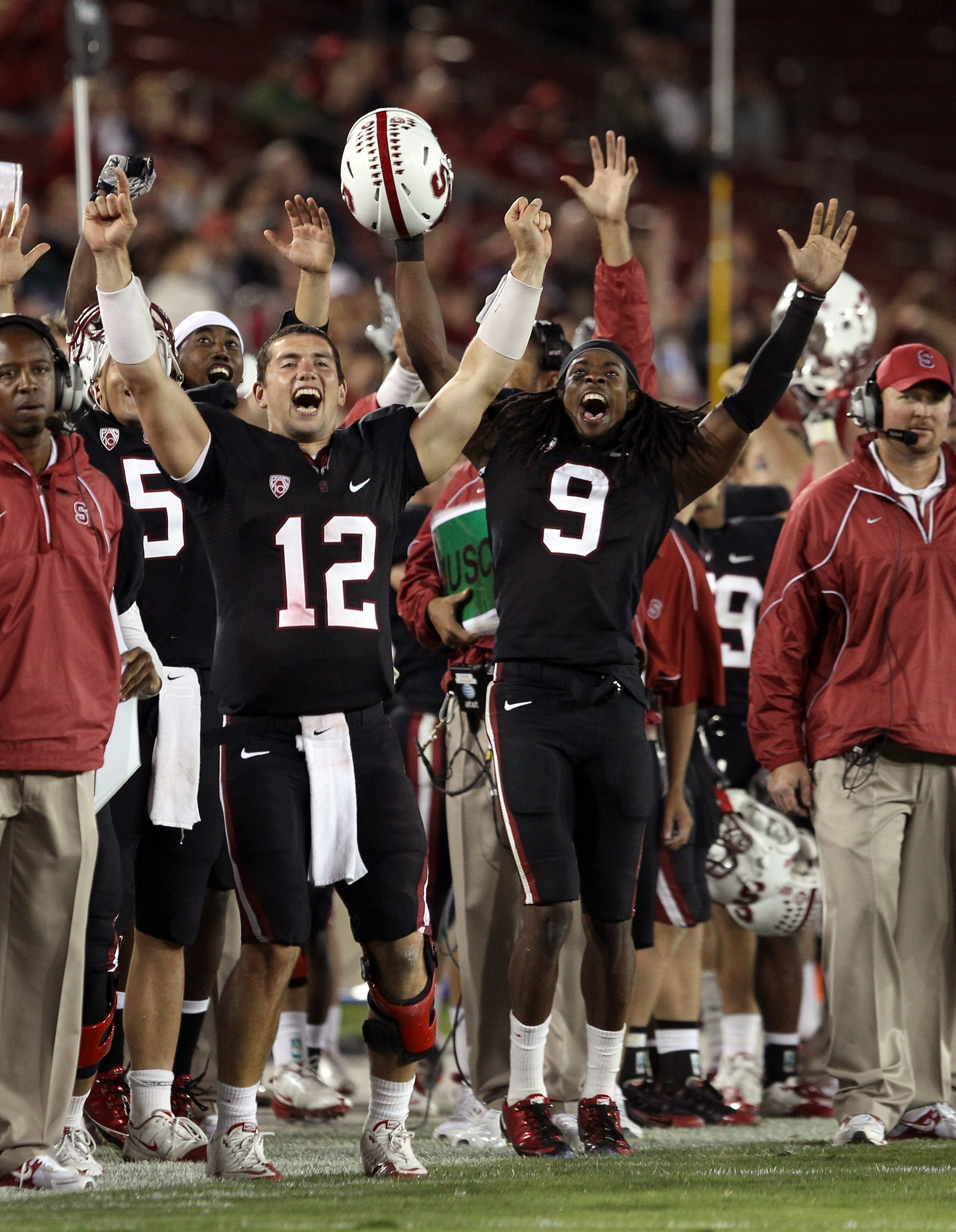 PALO ALTO, CA - SEPTEMBER 18:  Andrew Luck #12 and Richard Sherman #9 of the Stanford Cardinal celebrate from the sidelines after Stanford scored a touchdown to go up 67-24 in the fourth quarter of their game against the Wake Forest Demon Deacons at Stanf