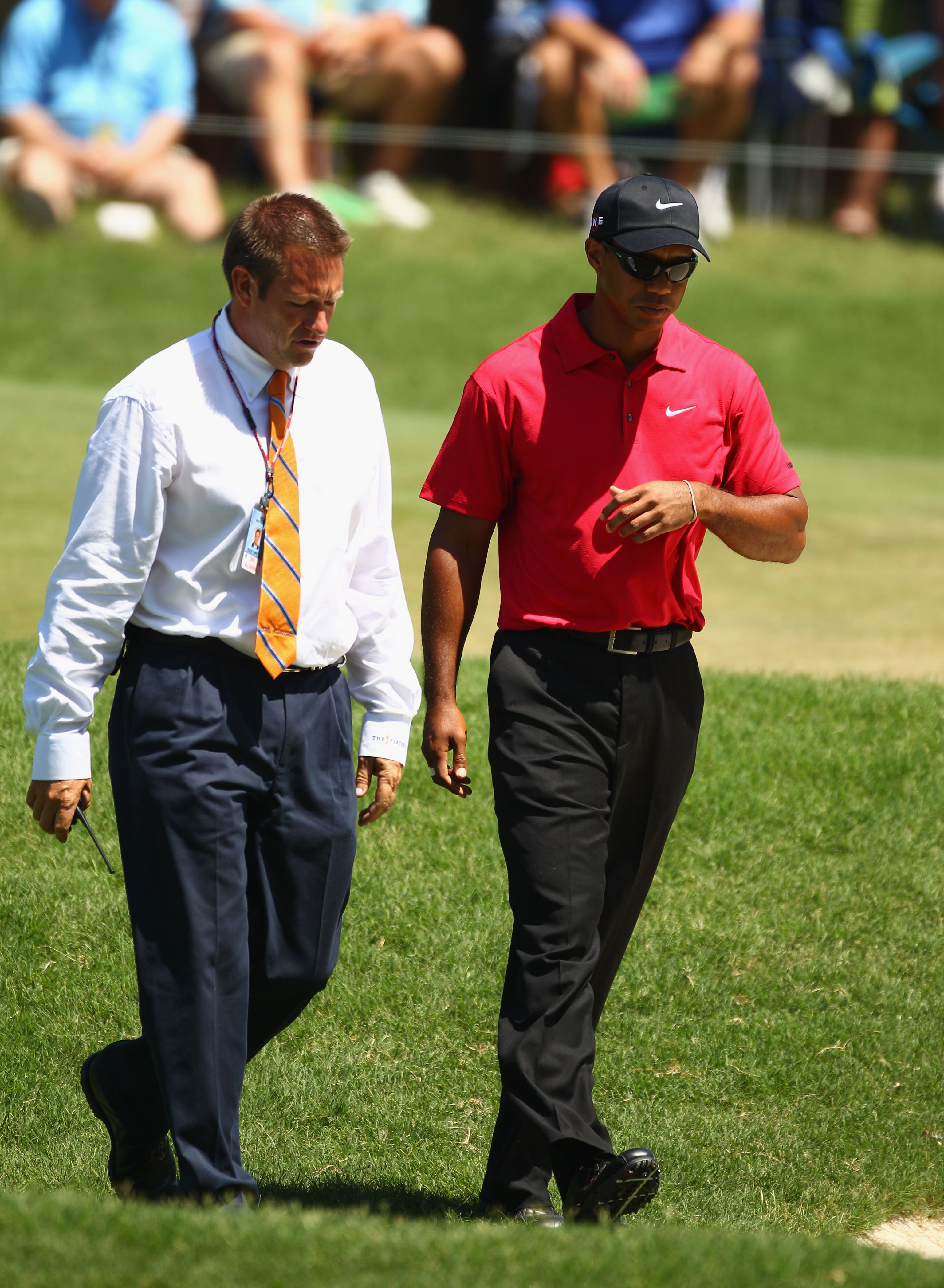 PONTE VEDRA BEACH, FL - MAY 09:  (L-R) PGA TOUR Rules Official Stephen Cox talks with Tiger Woods on the seventh hole where Woods withdraws due to a neck injury during the final round of THE PLAYERS Championship held at THE PLAYERS Stadium course at TPC S